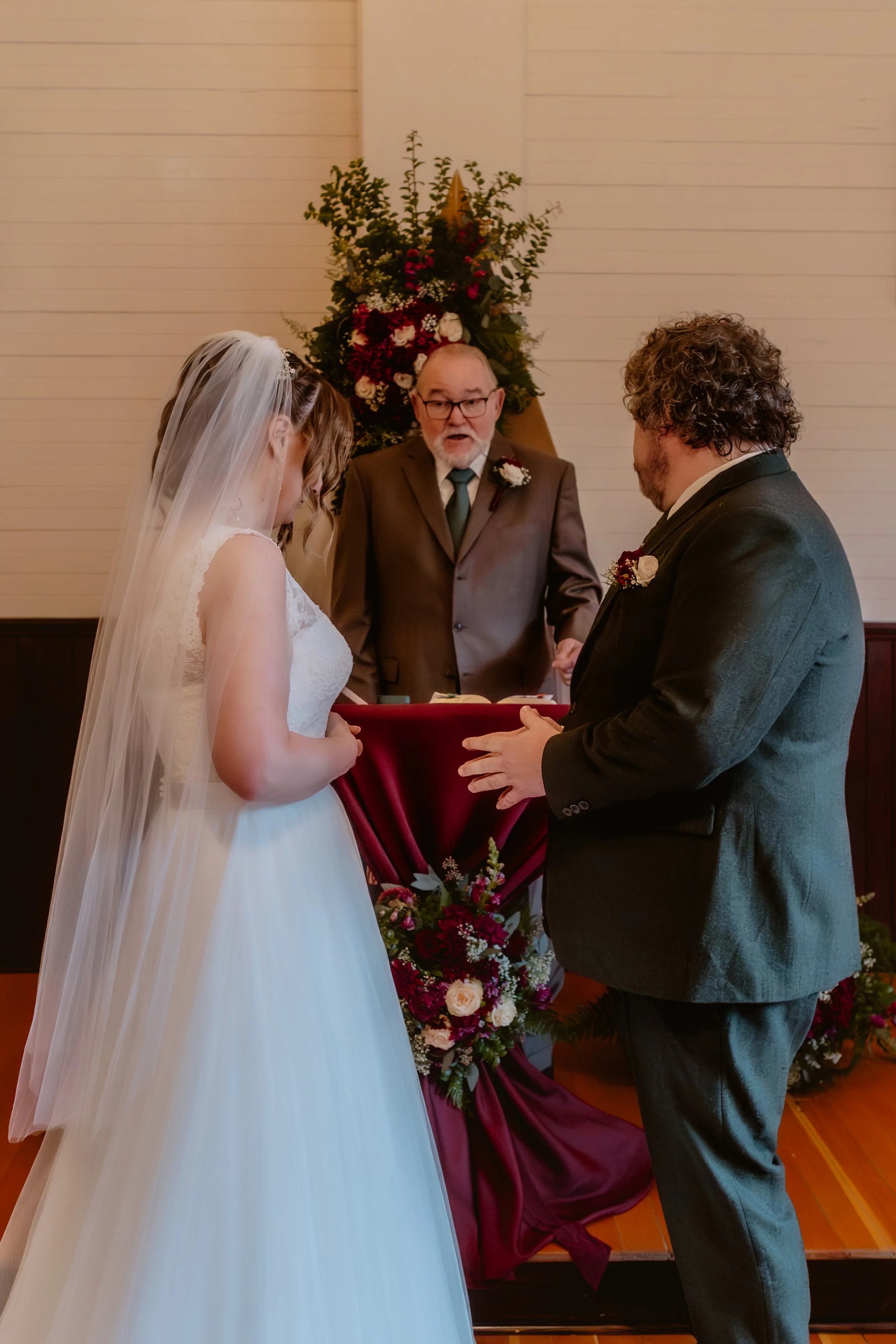 Bride and groom exchanging vows inside Hummingbird Hall