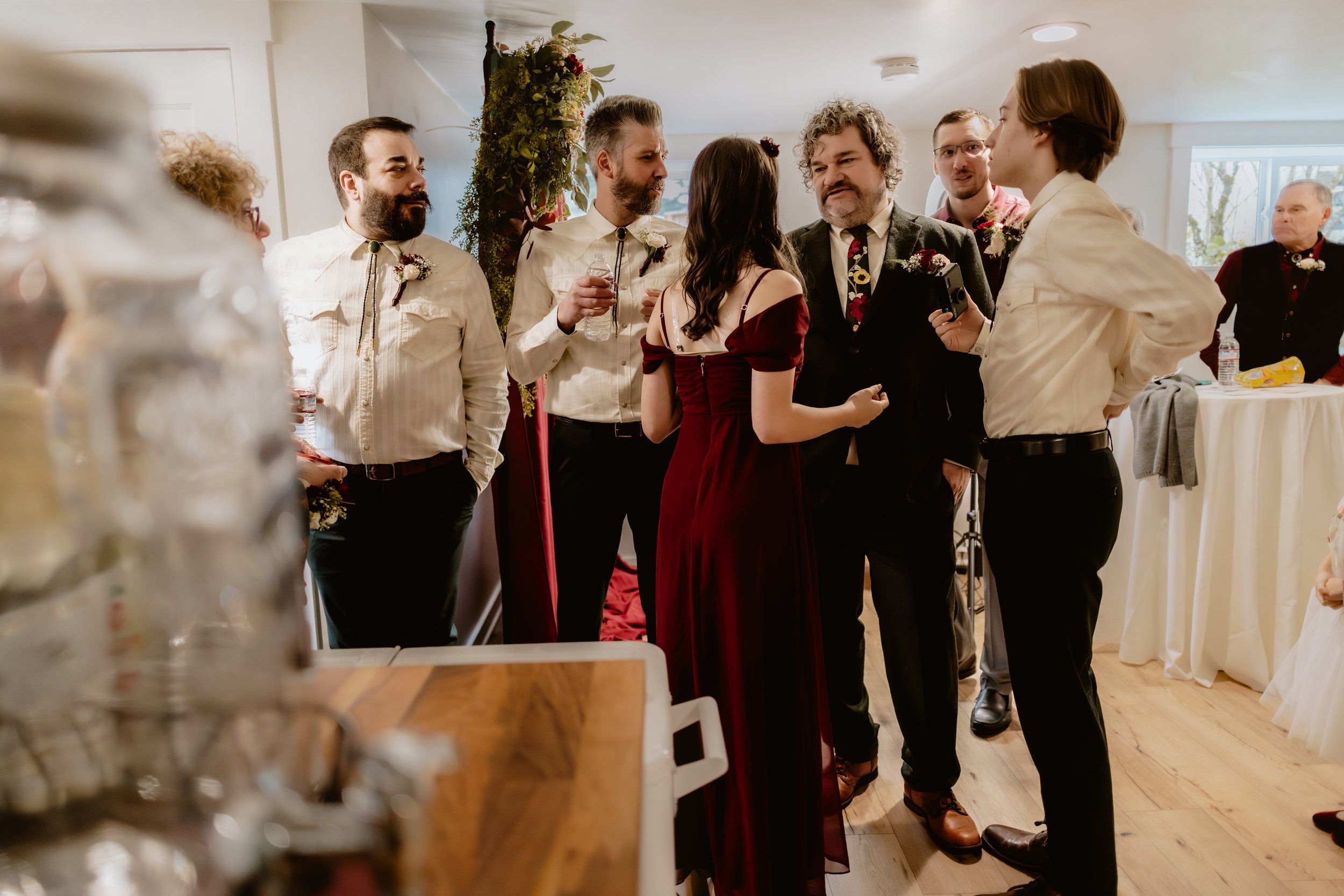 Newlyweds celebrating with guests in the Lower Hall at Hummingbird Hall