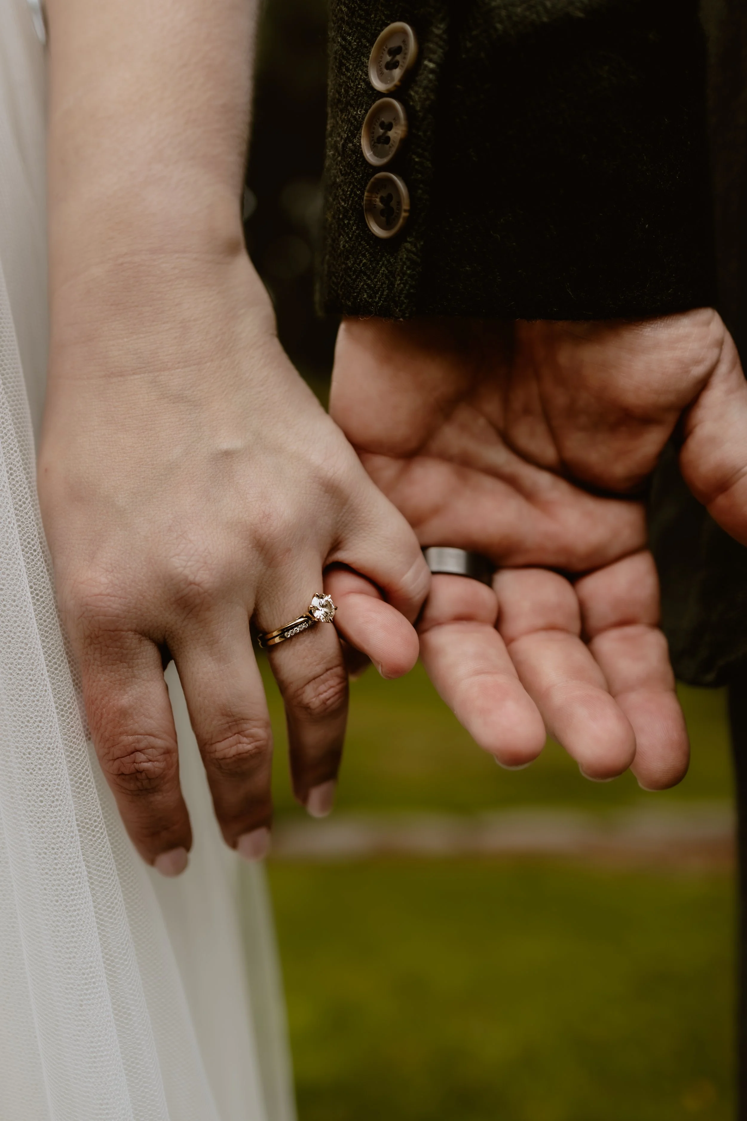 Newlyweds holding hands showing their wedding rings