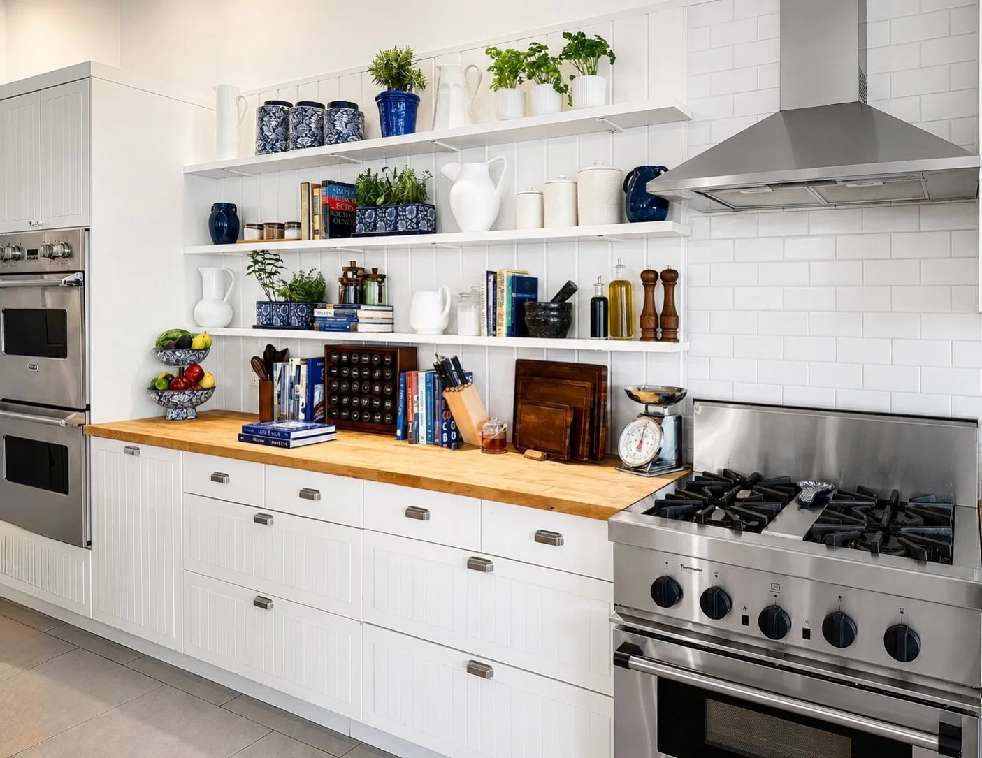 Dinner party perfection by Cottone &amp; Co &mdash; where timeless design meets effortless entertaining. Crisp whites, warm wood, layered textures, and shelves styled like a still life made for slow evenings, good wine, and even better conversation. 