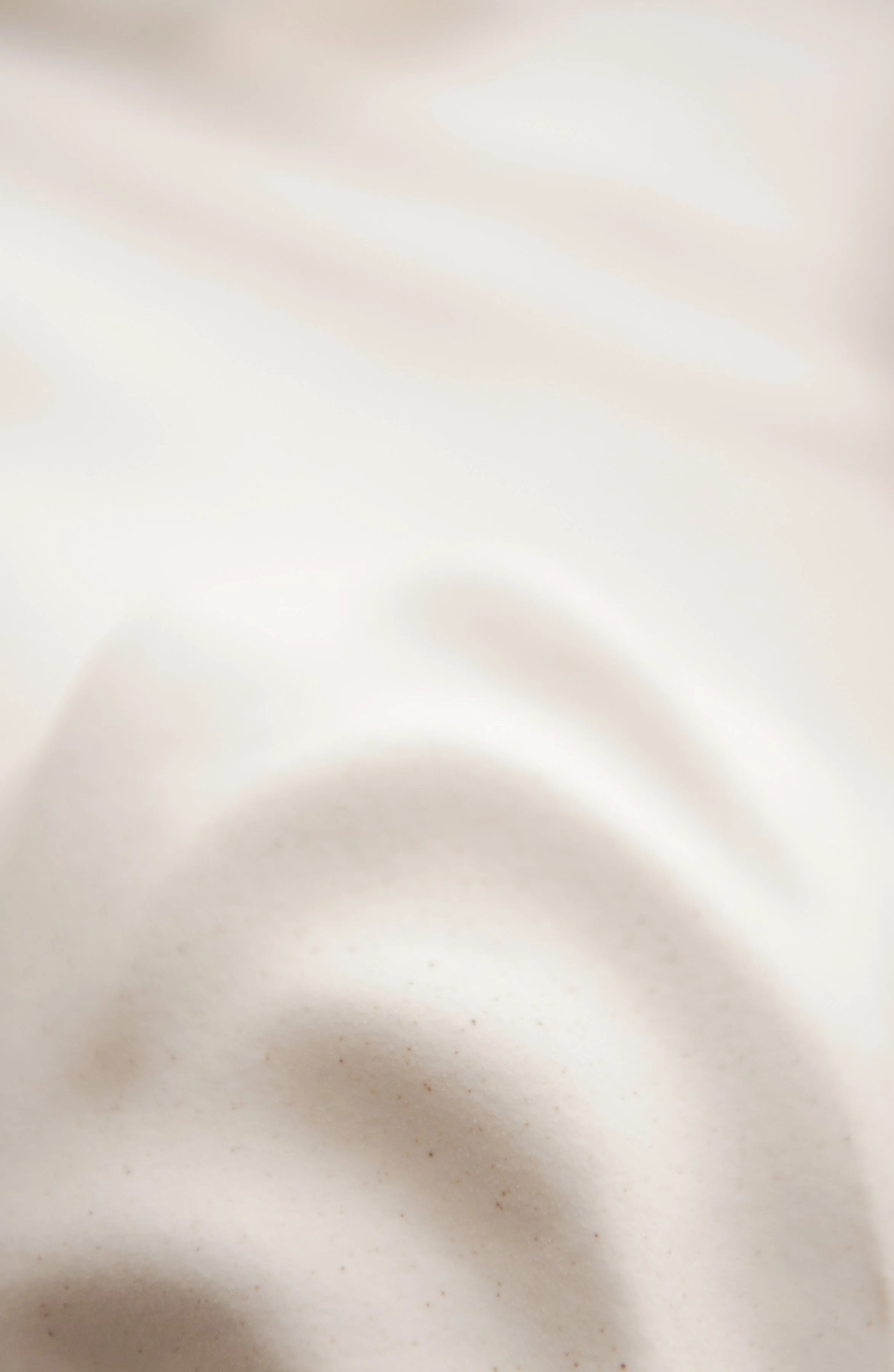 Close-up of a white surface with shadows and slight discoloration.