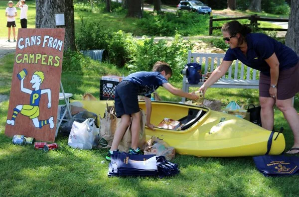 Setting up the collection site for the food drive at Camp Pemi's Cans From Campers community service project.