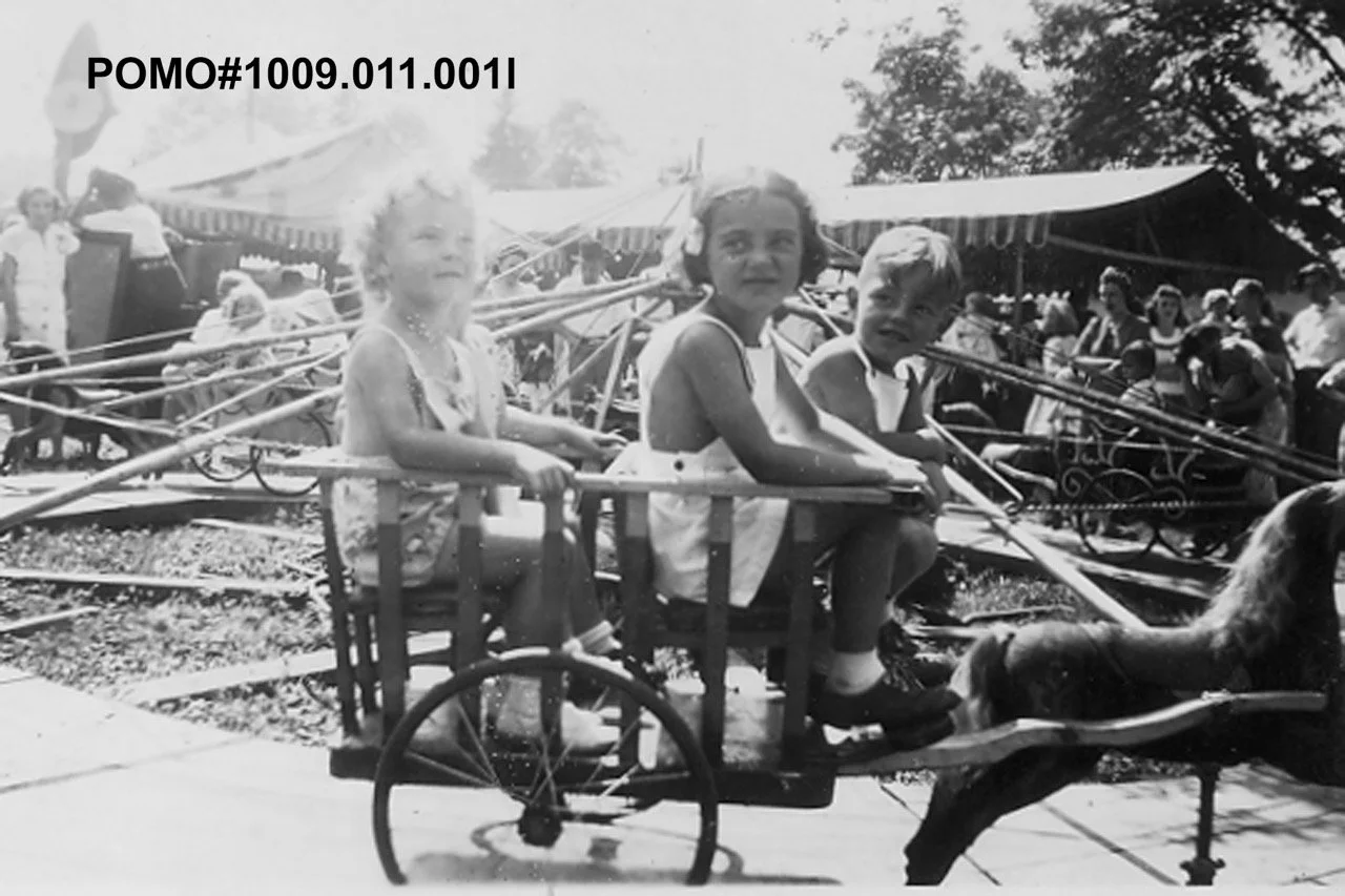 POMO# 1009.011.001l
Port Moody Carnival, no date, children on a horse and buggy merry-go-round ride. Date Unknown.