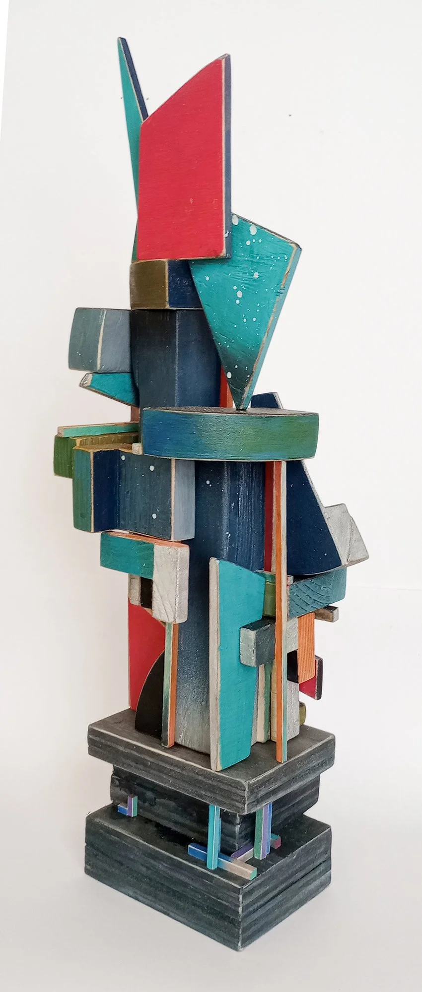 Colorful abstract wooden sculpture with geometric shapes and various bold colors.