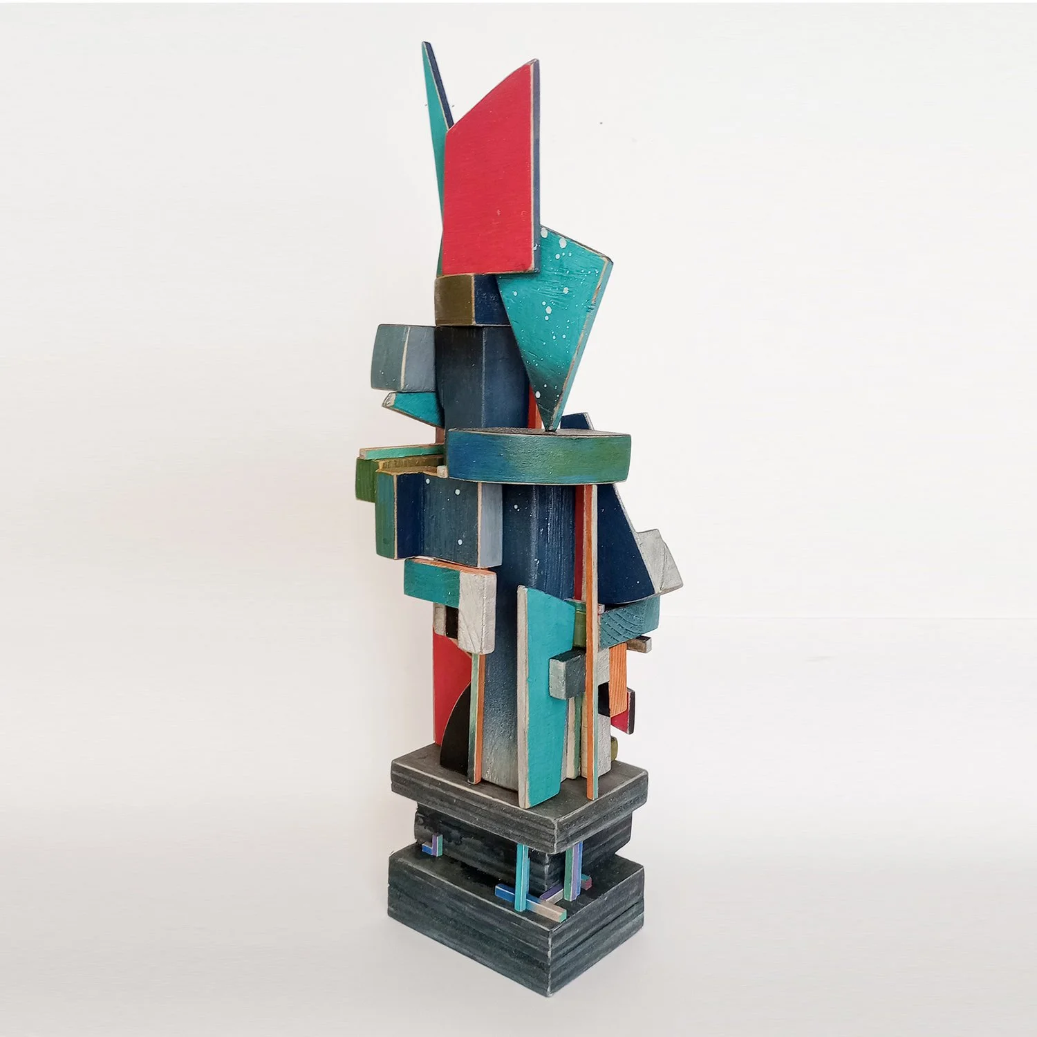 Colorful abstract wooden sculpture with geometric shapes and various bold colors.