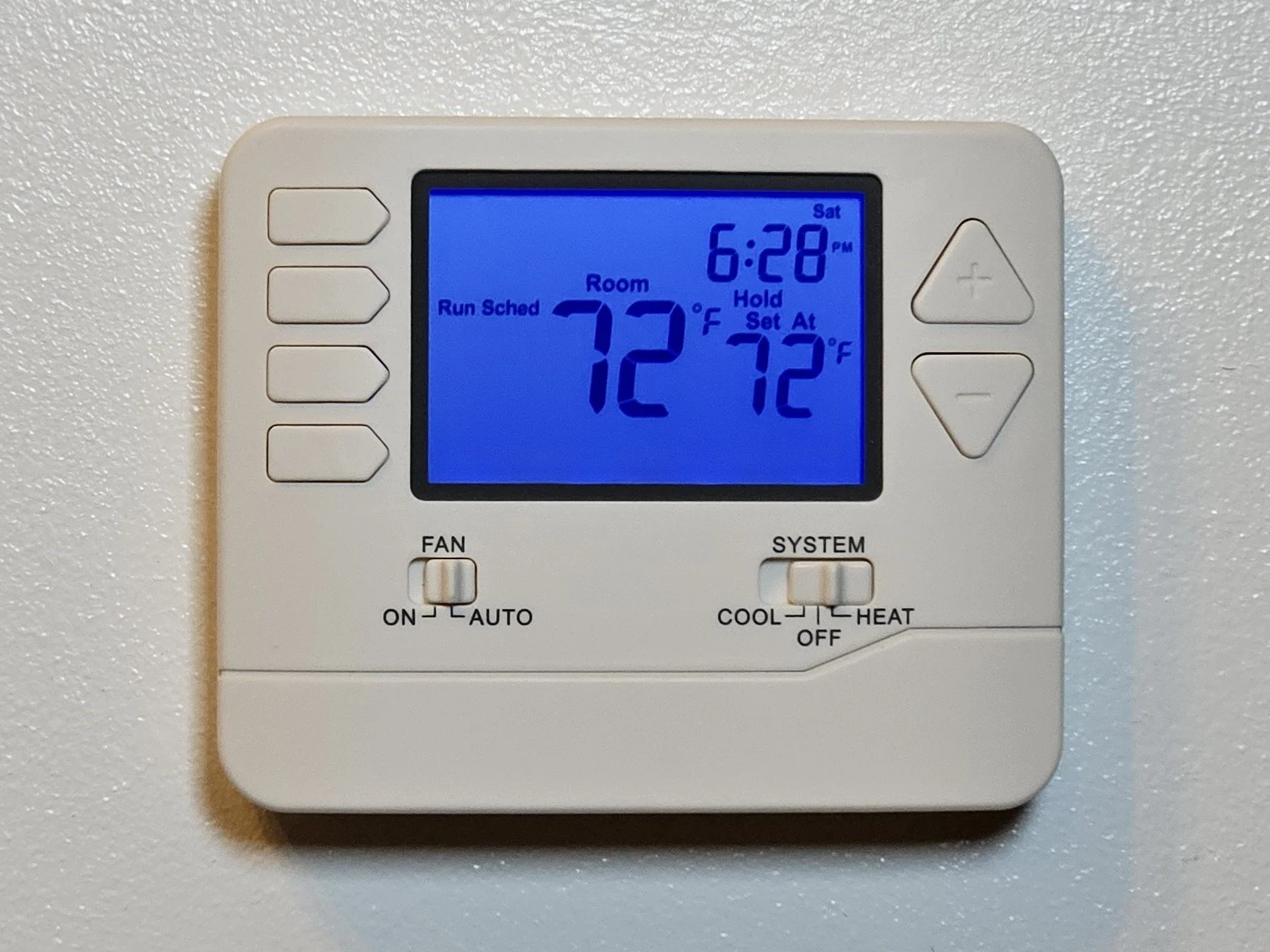 A digital thermostat displaying a room temperature of 72°F, set to 72°F, with a time of 6:28 PM on Saturday.