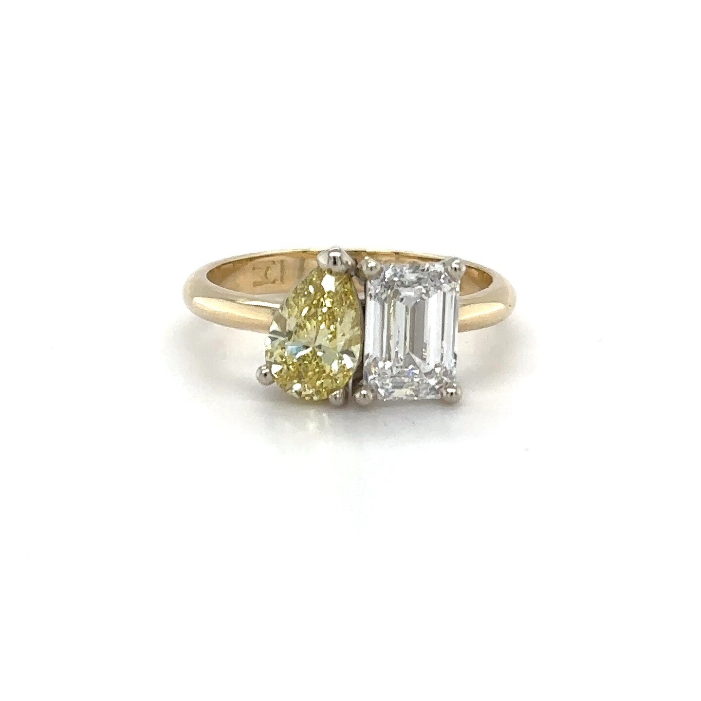 Check out this stunning yellow gold Toi et Moi ring. The yellow pear cut diamond perfectly complements the white emerald cut diamond, creating a mesmerizing contrast that catches the light from every angle. It&rsquo;s a symbol of love, unity, and sty