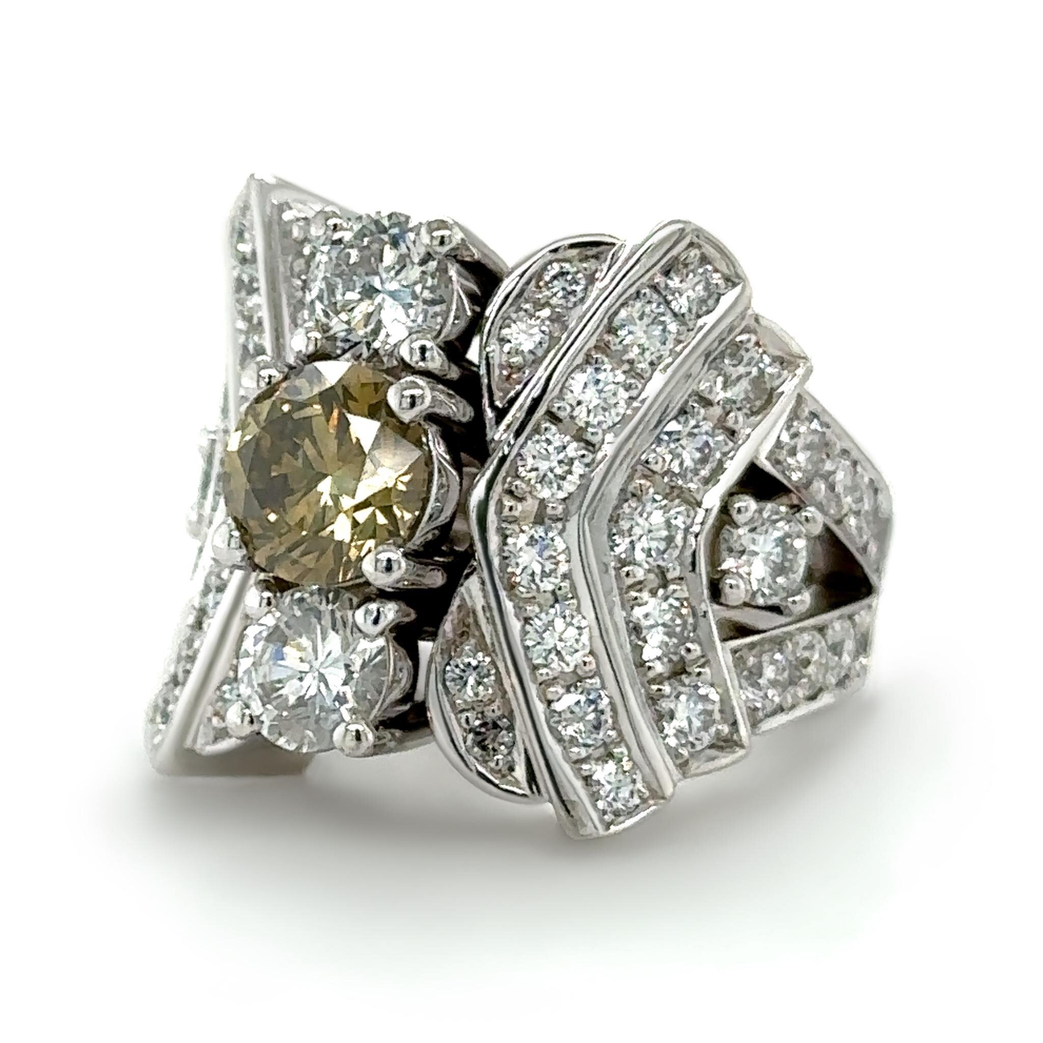 This amazing white gold ring was created for a customer who had quite a few different rings she collected over the years and wanted them made into one ring. With lots of stones to work with, including the beautiful yellow diamond in the center, we ca