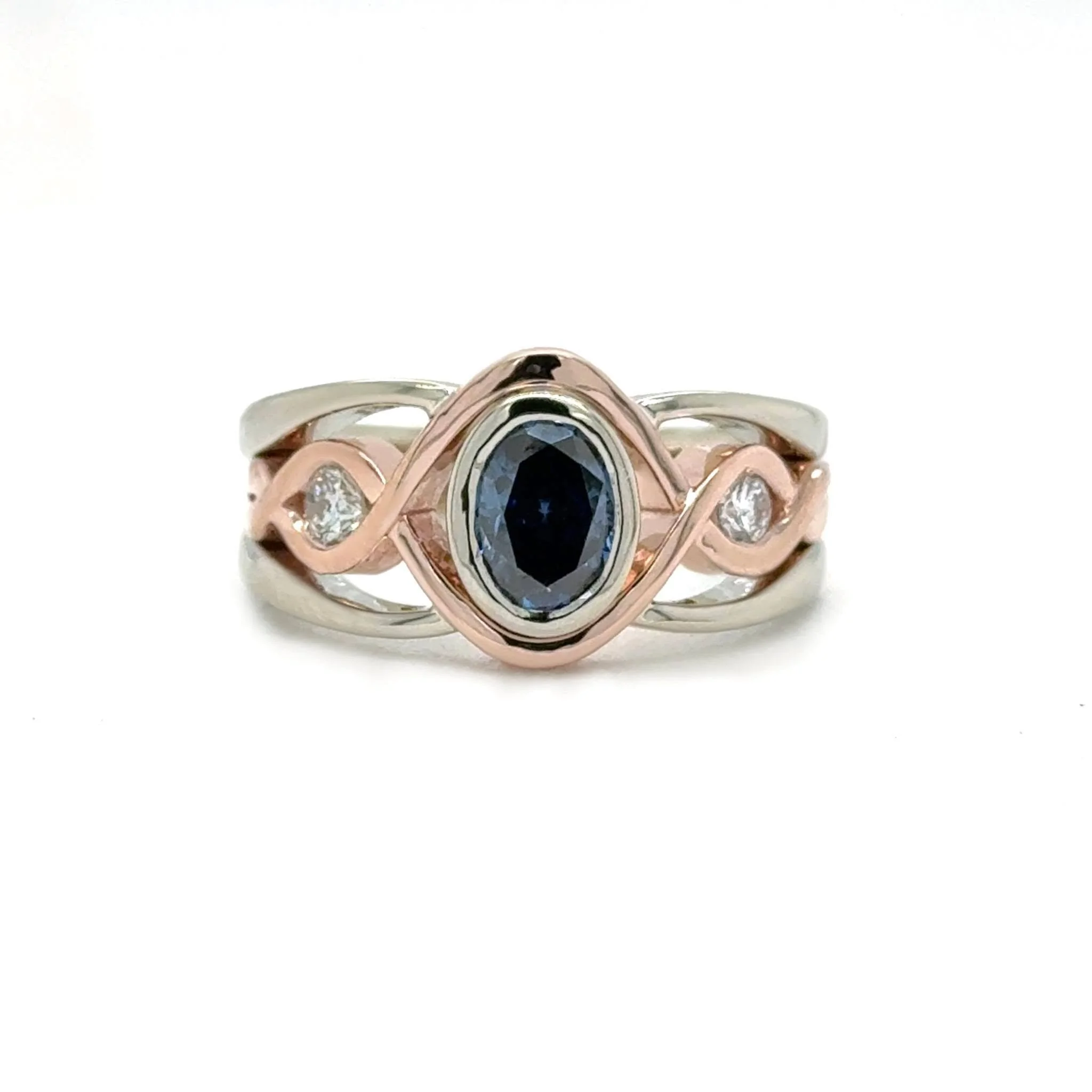 We took the main stones from two very sentimental rings and gave them a whole new life, placing them on either side of a beautiful blue moissanite. Finished in rose and white gold, this ring brought together two meaningful pieces of the past to creat