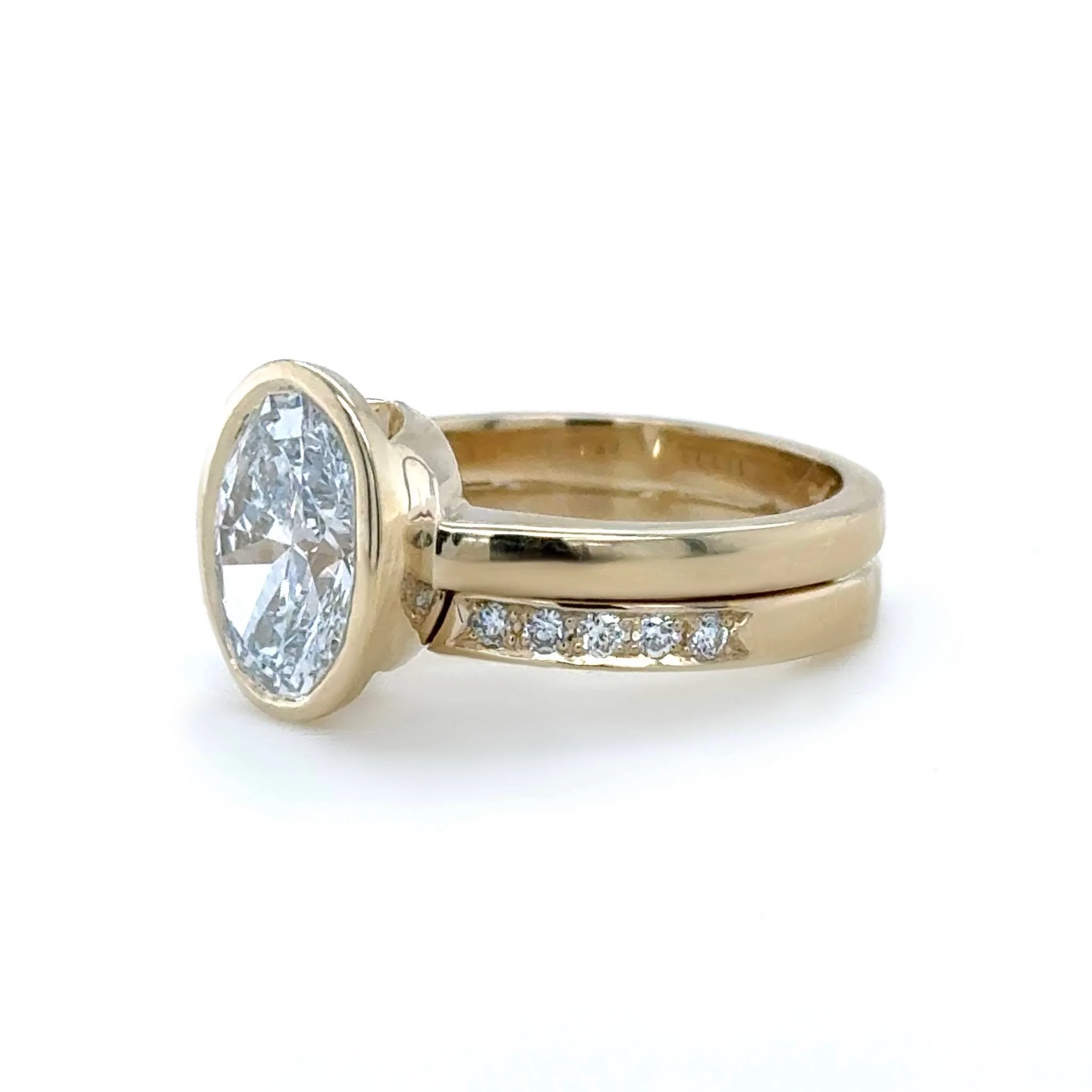 This ring is a great example of how we can get plenty of size and sparkle while keeping the overall design low, comfortable, and durable.

The fitted wedding band is split at the top, creating the illusion that it goes all the way around the center s