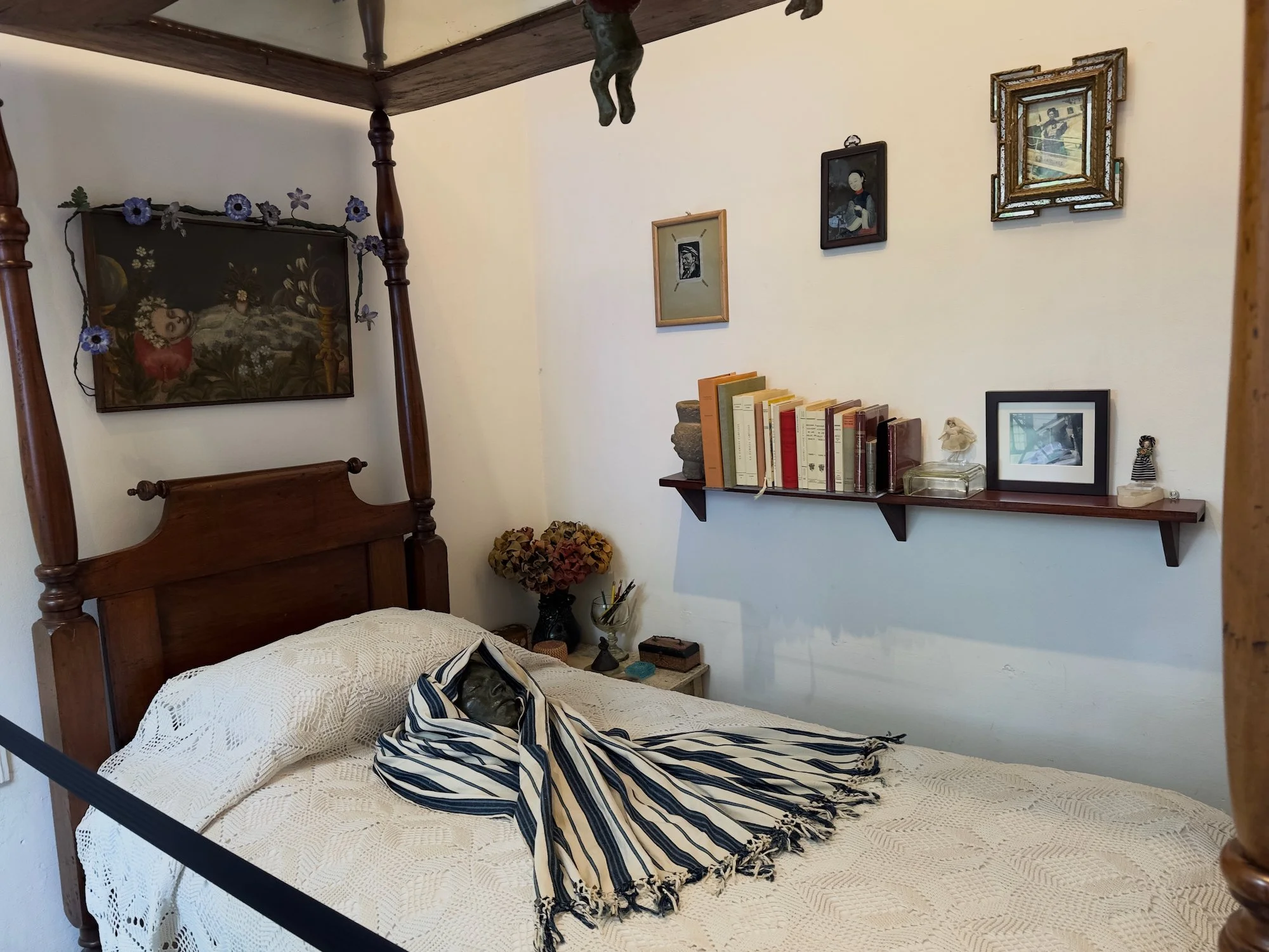 Casa Azul. This is the deathbed of Frida Kahlo. She had a very rough final few months that included having one of her legs amputated. 
 Above her on the canopy is a framed picture of butterflies, which, in traditional Mexican folklore are transitiona