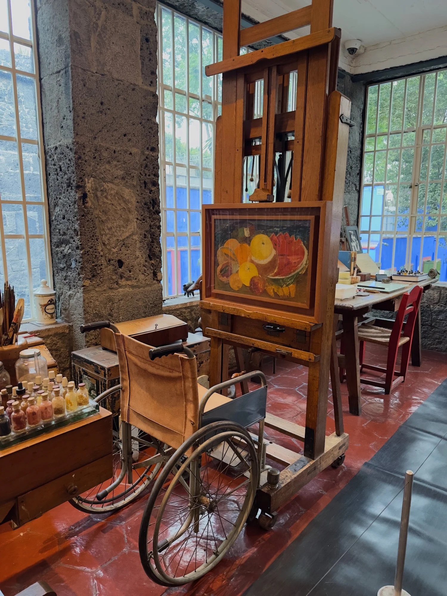 Casa Azul: This is Frida Kahlo's easel and wheelchair, and just beyond is a worktable. 