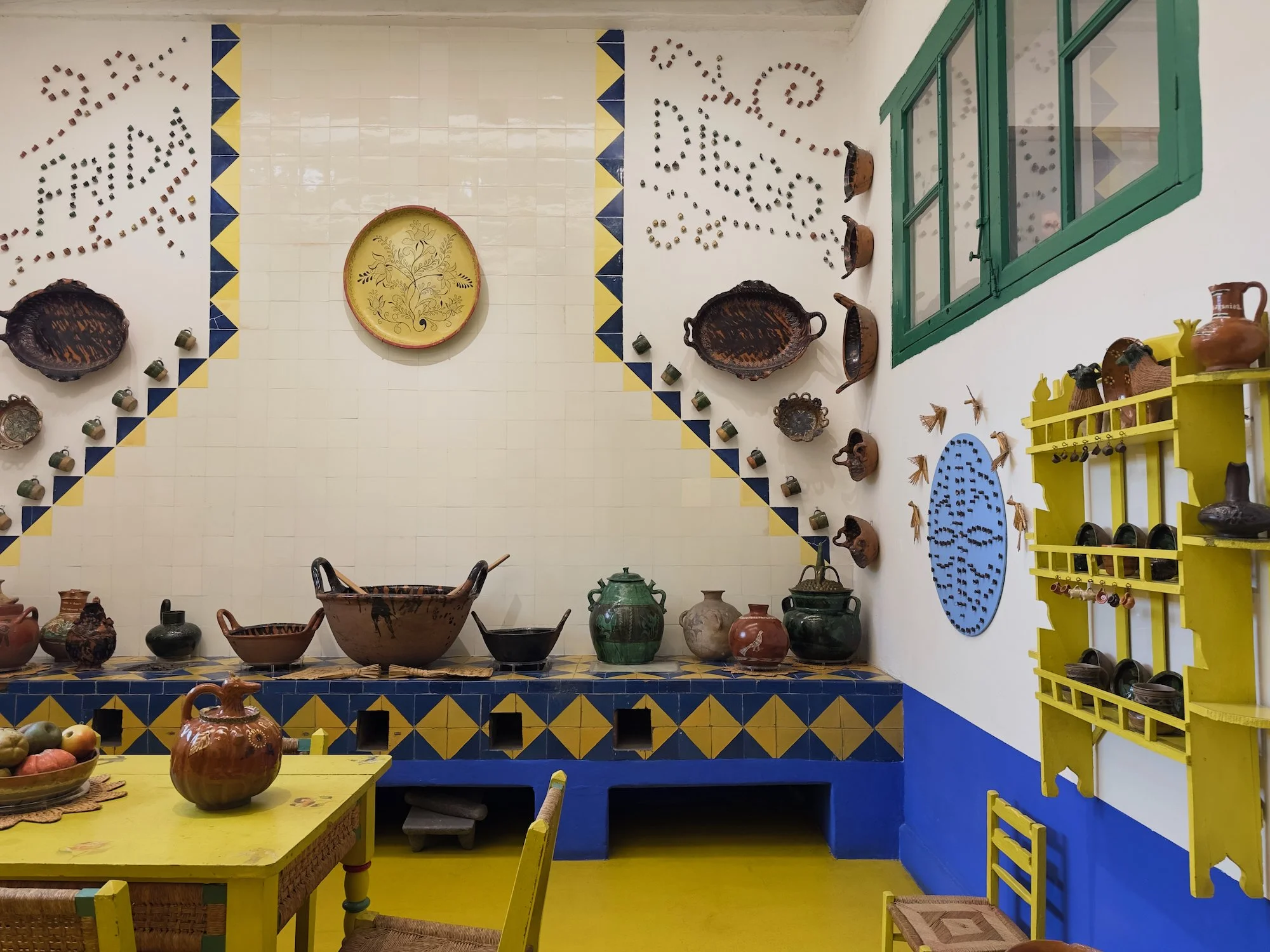 Coyoacán:  This is the kitchen at Casa Azul with the names Frida and Diego on the wall. Diego Rivera lived here with her for a time.