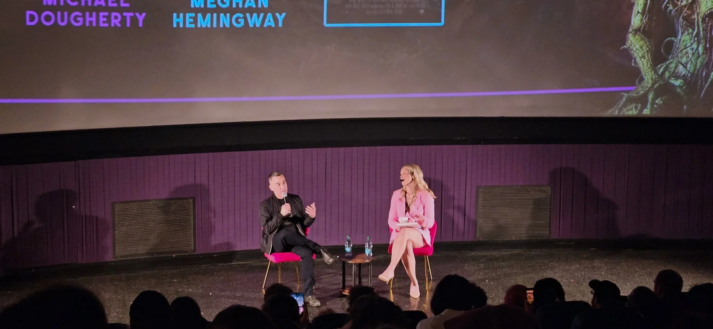 Director Michael Dougherty is seated on stage with Meghan Hemingway in a Q&A session for Trick R Treat at Vancouver Horror Show 2026.