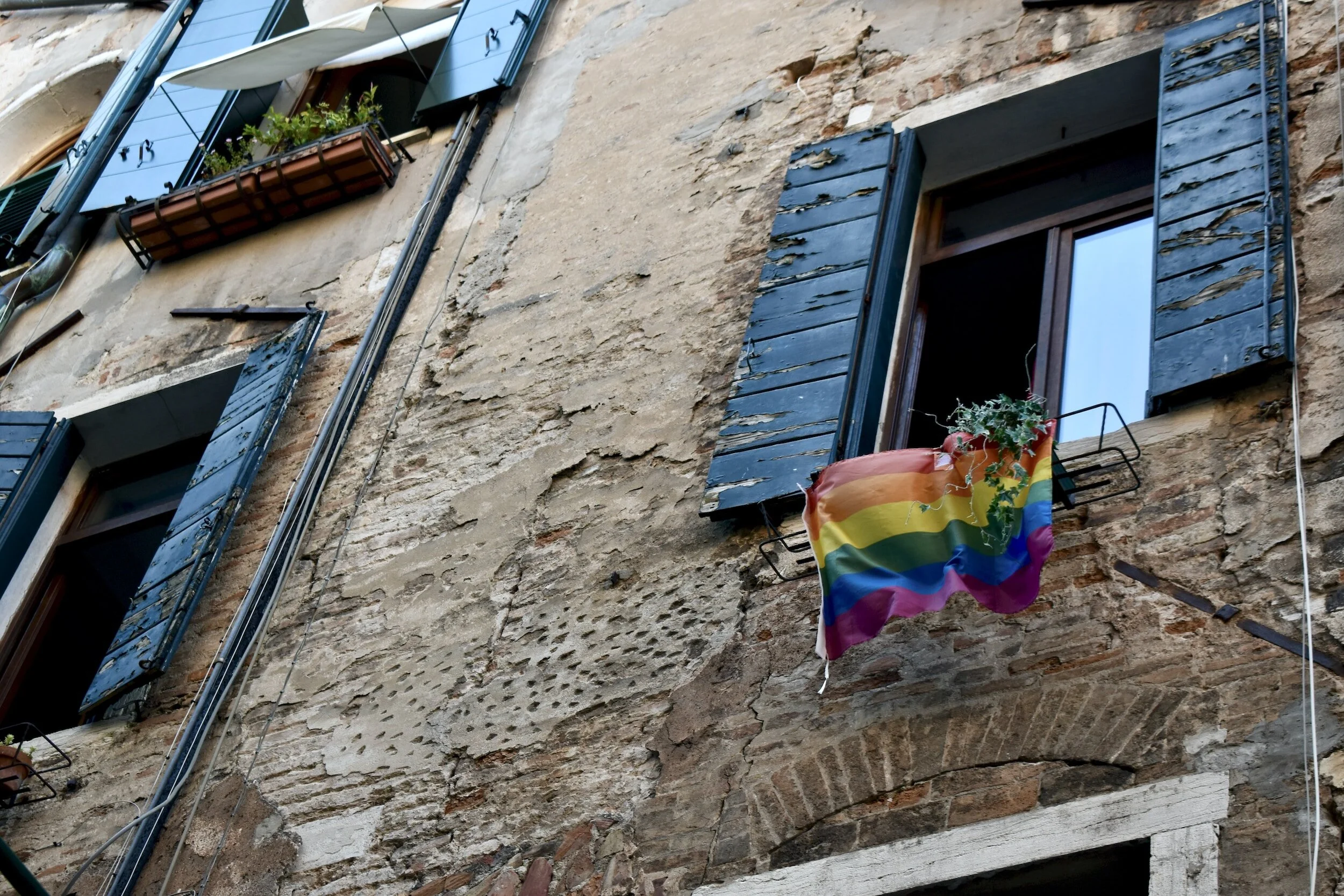 pride flag hanging outside a building