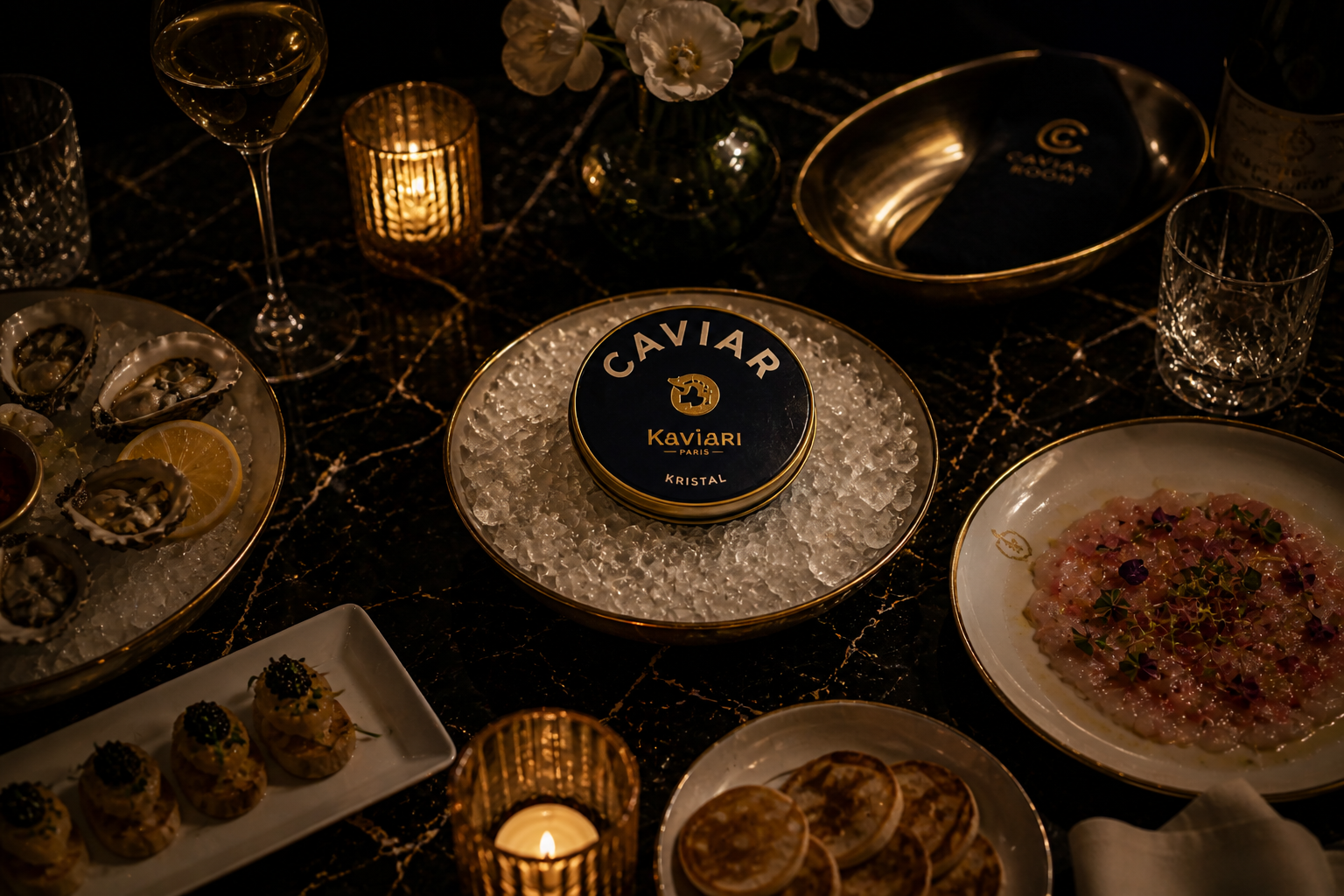 Elegant dinner table with dishes, caviar, champagne, and decorative elements.