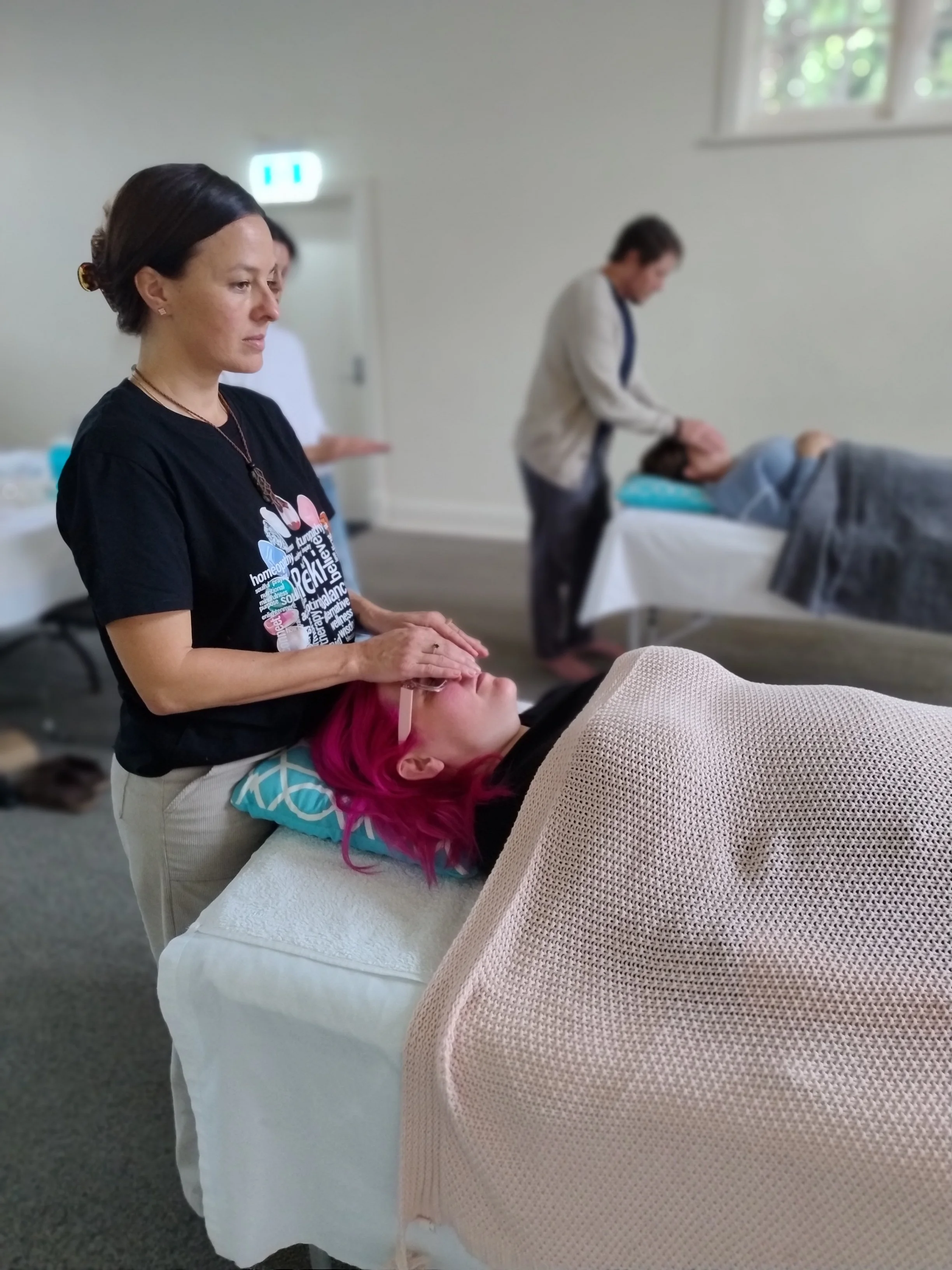 Reiki Master demonstrating hands on positions Reiki Training Adelaide.