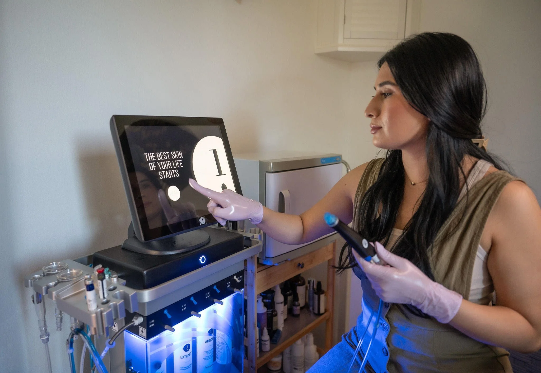 ESTHETICIAN PERFORMING A DMK MASK ON A CLIENT