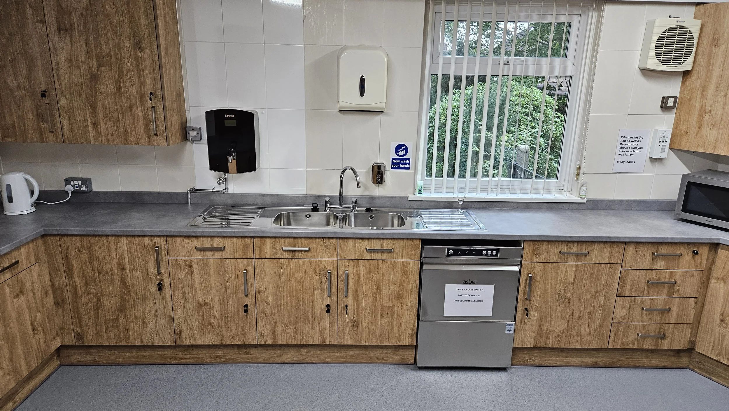A twin sink/drainer and a hot water boiler for tea/coffee making. The glass washer is for Village Hall Committee Member use only.