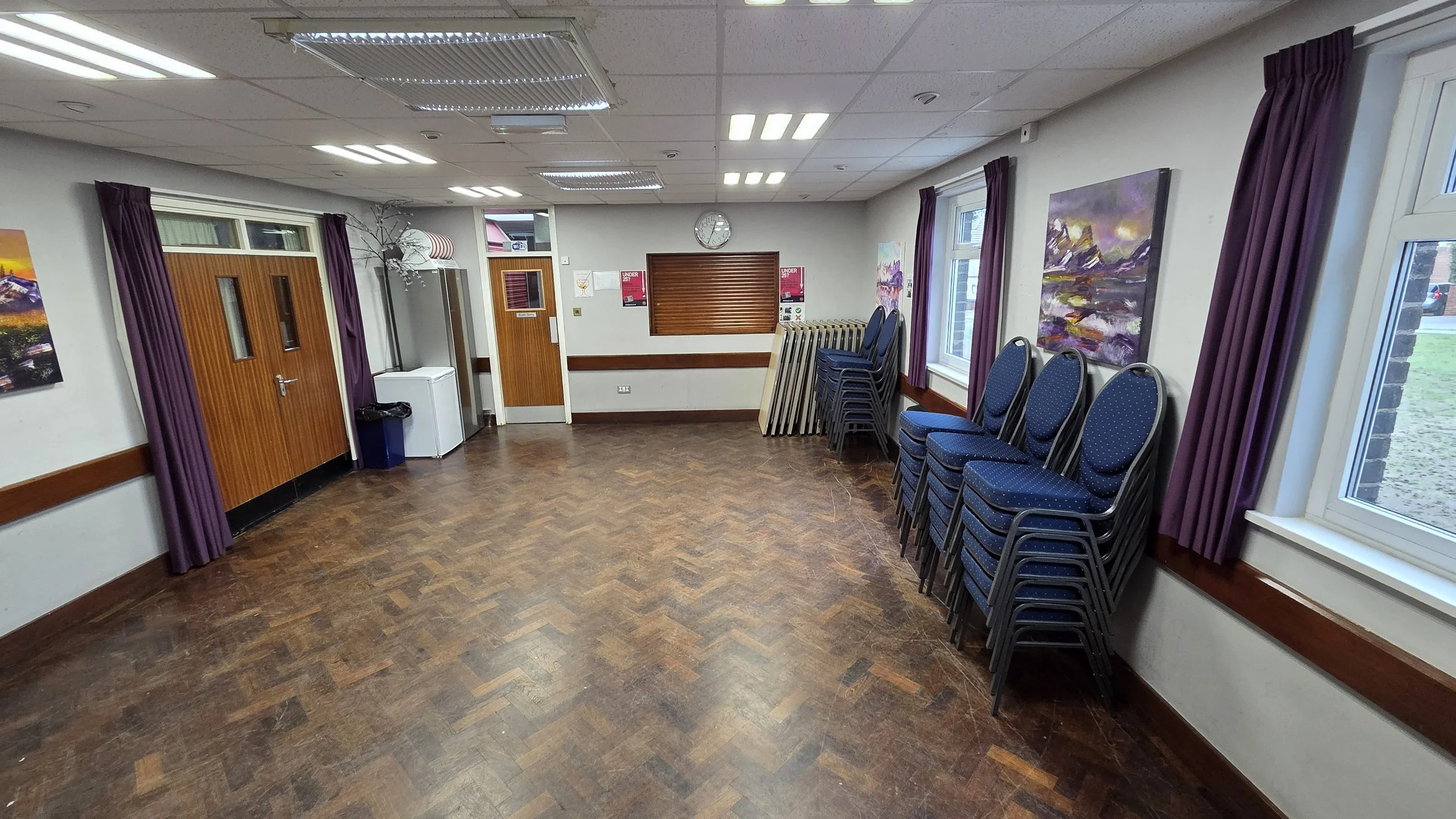 In addition to the Main Hall, we have a small committee room called the Brammer Room. The double door on the left leads to the Main Hall. The single door in the middle leads to the toilet corridor and main entrance. The wooden hatch is our fully lice