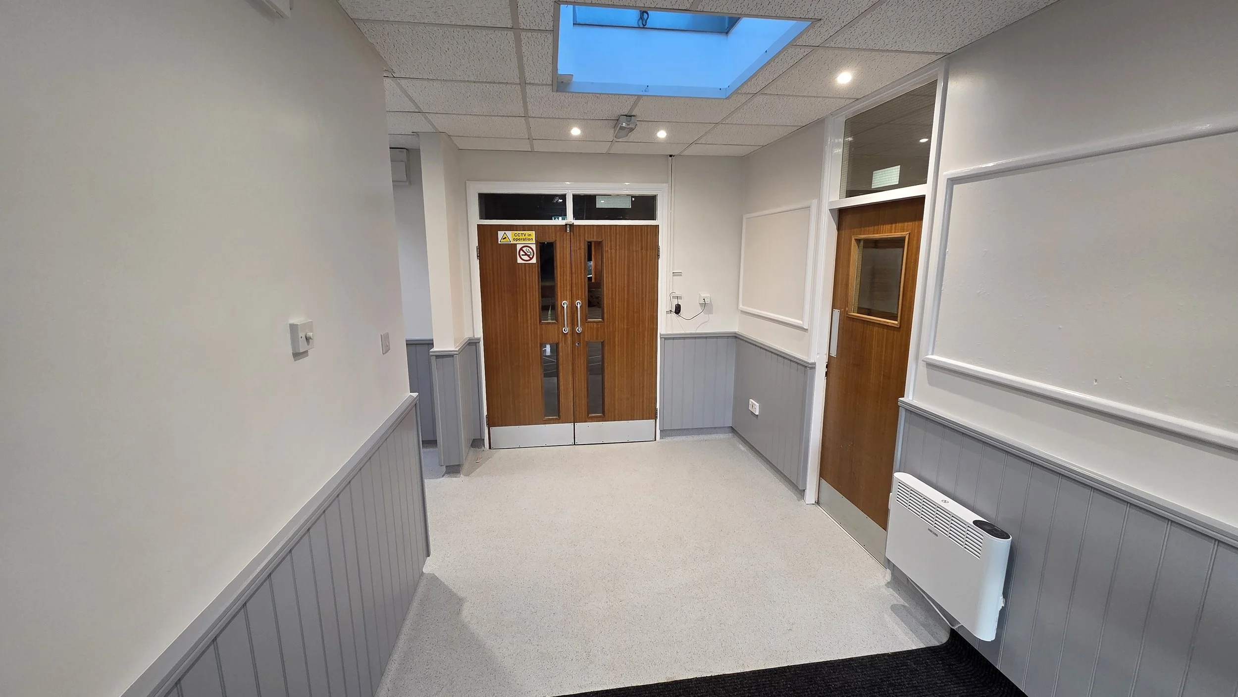 This is our main entrance refurbished in August 2026. The door on the right leads to the kitchen and the double doors lead to the Main Hall.