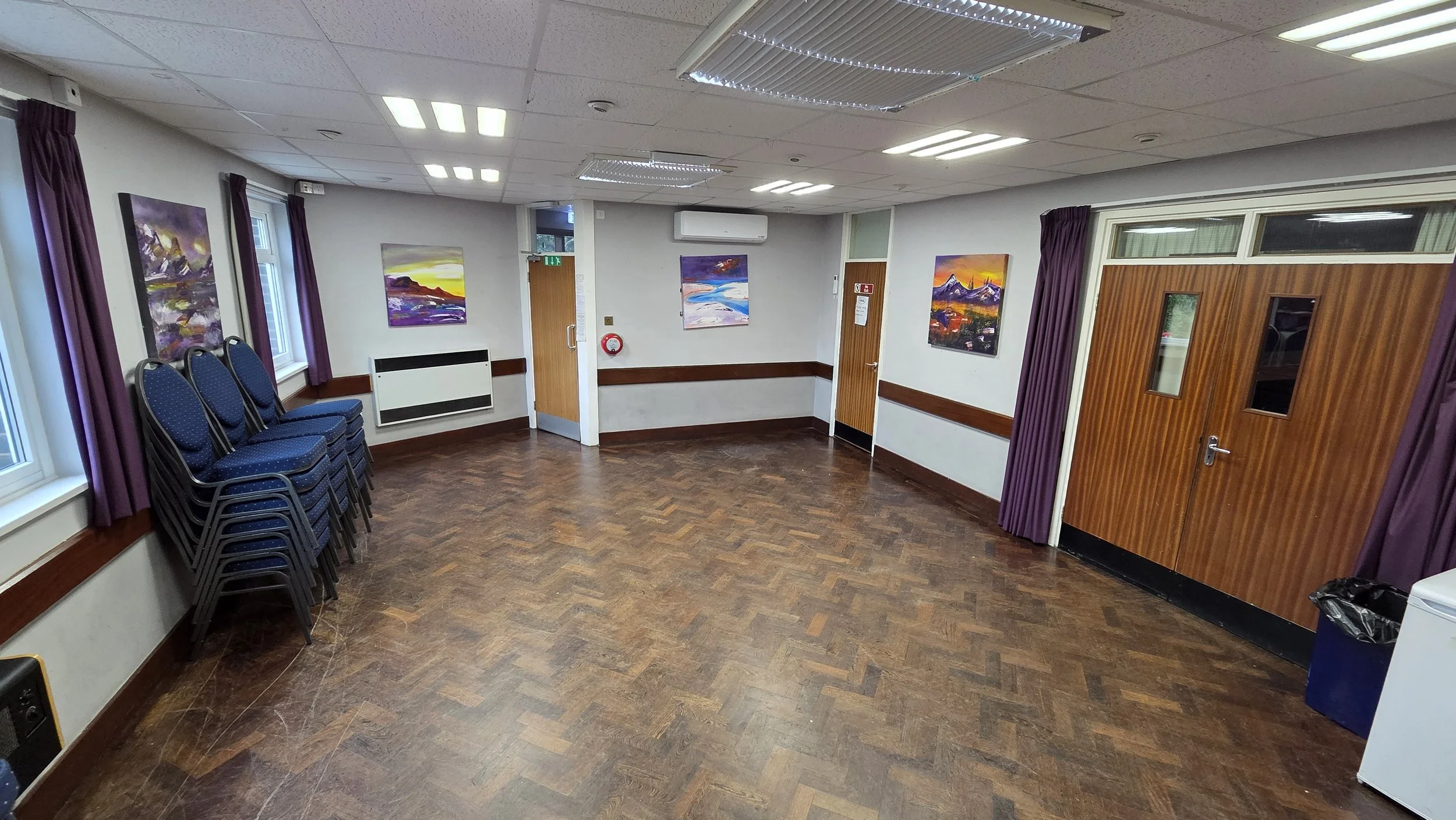 In addition to the Main Hall, we have a small committee room called the Brammer Room. The photo is taken from the bar hatch. The double doors on the right lead to the Main Hall auditorium. The adjacent single door leads to the stage and the stage und