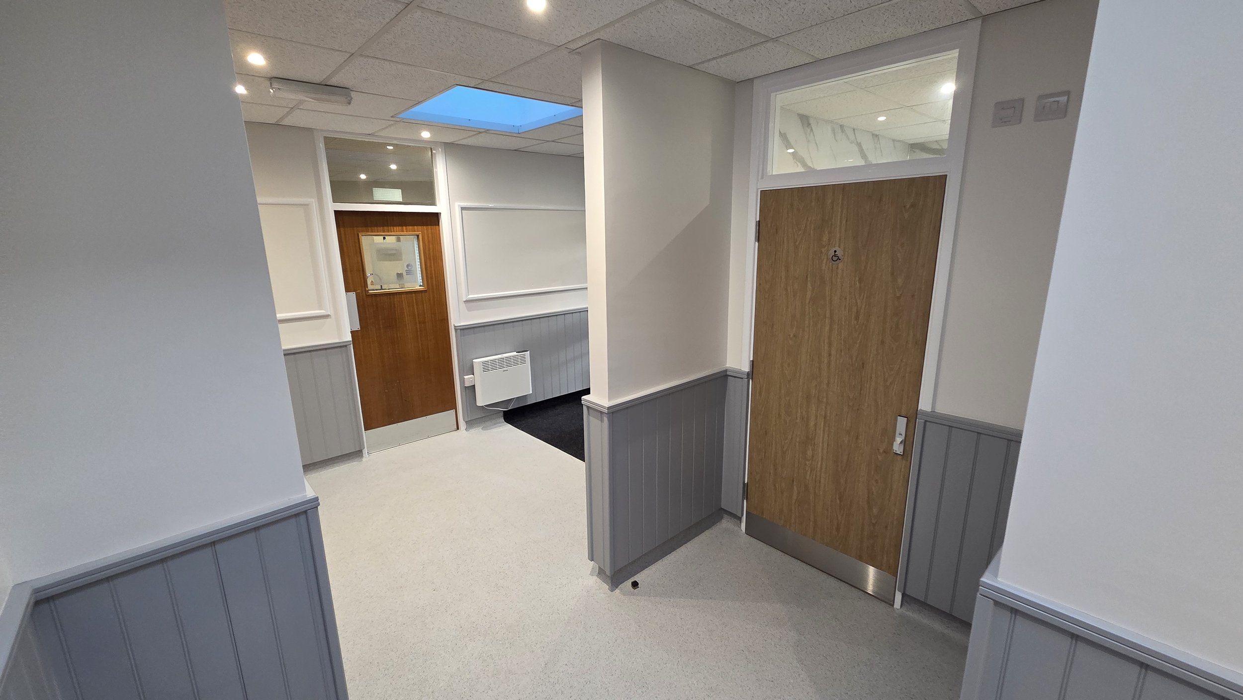 The door on the right is the Accessible Toilet and the door in the middle is the Kitchen door.