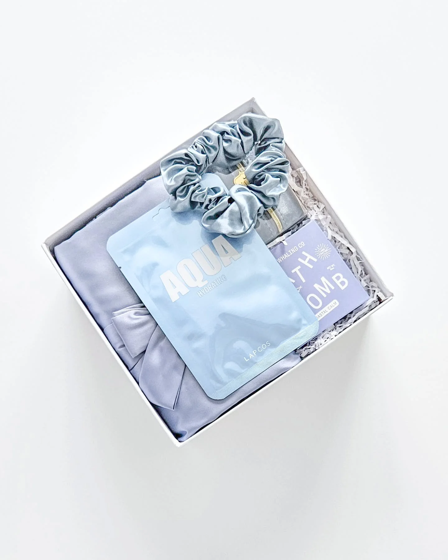MEET SOMETHING BLUE: 

From silk sleep essentials to satin softness, this gift box is designed to spoil her on the most important day. Would you add this to your wedding morning?

WHAT'S INCLUDED:

- Coastal Calm Bath Bomb
- Aqua Sheet Mask
- Silk Sc