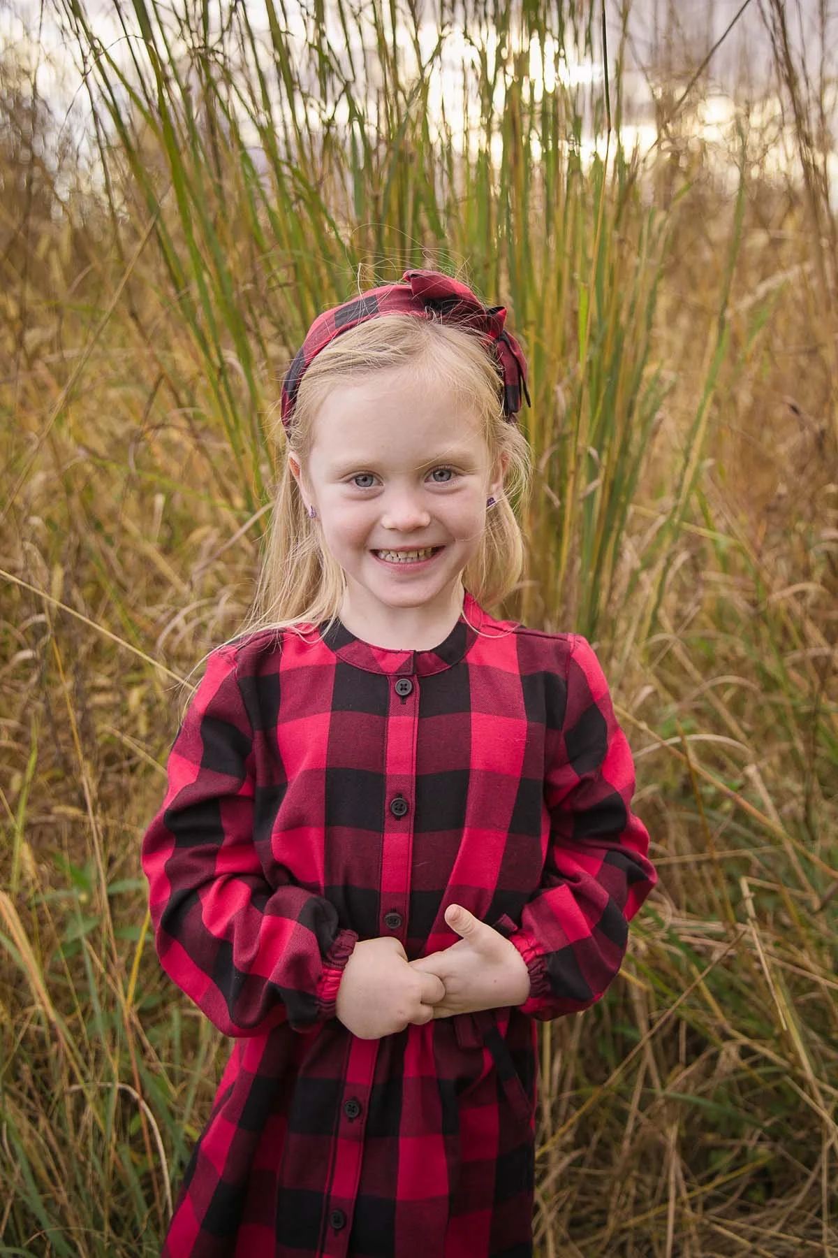 Girl Posed in a Field for Family Portrait in Huntingdon Valley PA by photographer Wonderland Portrait