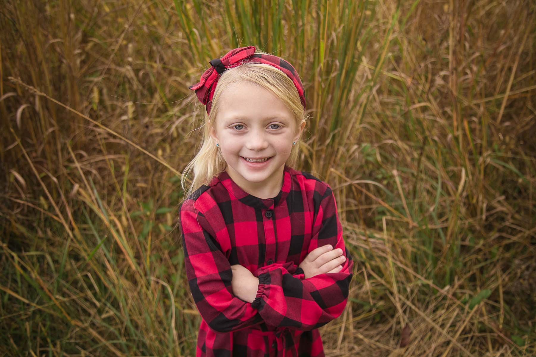 Girl Posed in a Field for Family Portrait in Huntingdon Valley PA by photographer Wonderland Portrait