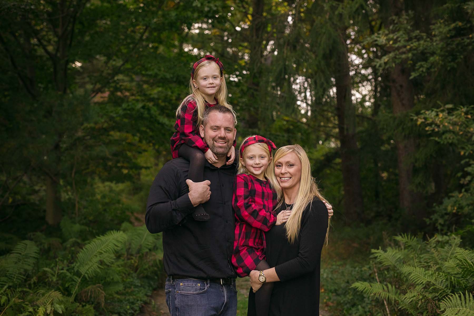 Family Posed in woods for Family Portrait in Huntingdon Valley PA by photographer Wonderland Portrait