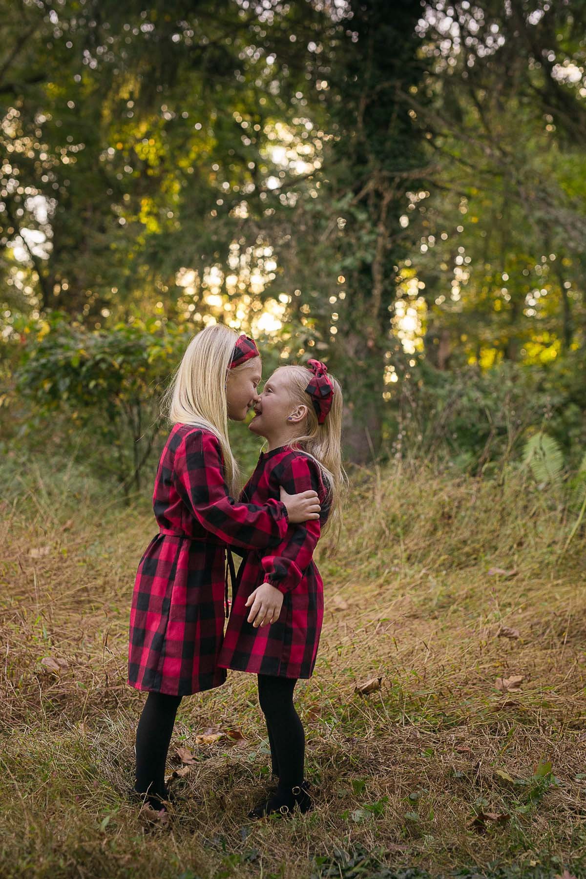 Sisters Posed in a Field for Family Portrait in Huntingdon Valley PA by photographer Wonderland Portrait