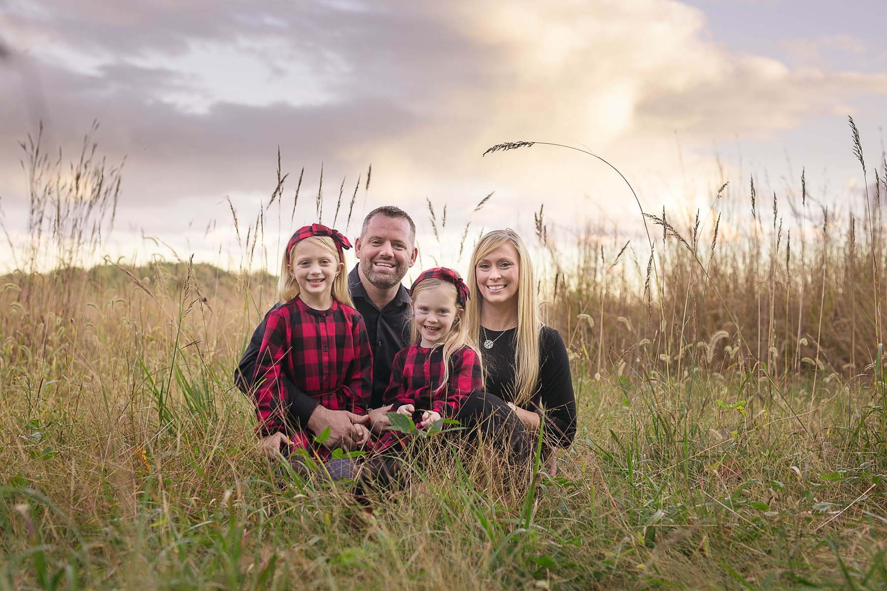 Family Posed in a Field for Family Portrait in Huntingdon Valley PA by photographer Wonderland Portrait