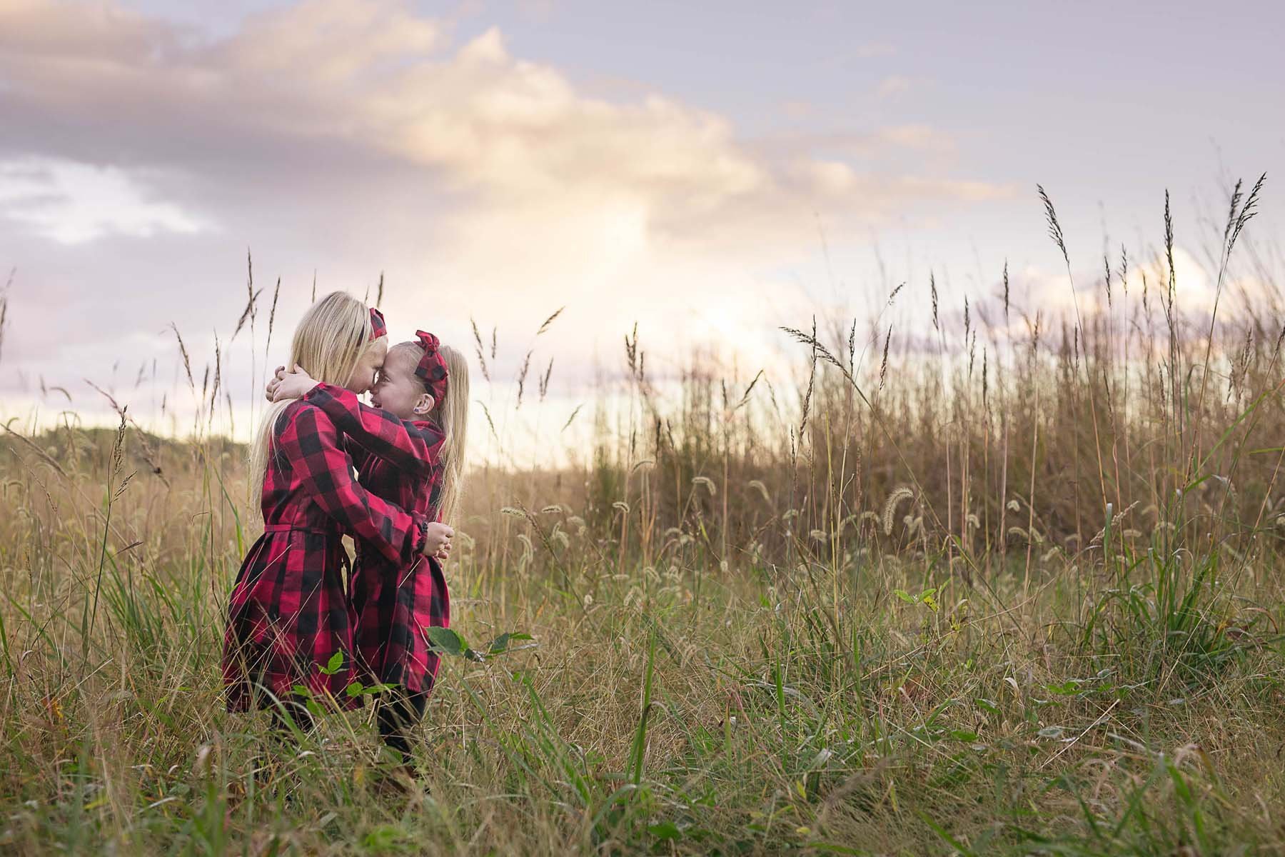 Sisters Posed in a Field for Family Portrait in Huntingdon Valley PA by photographer Wonderland Portrait