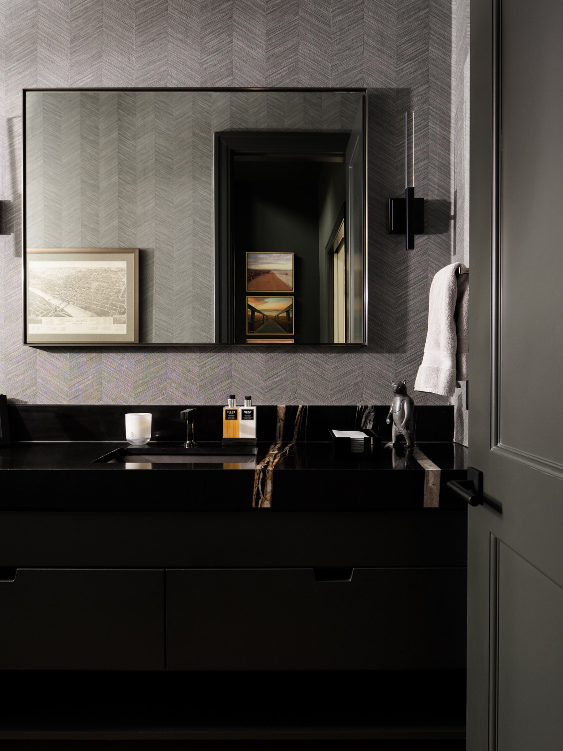 Dark cabinetry, dramatic stone veining, and a subtle herringbone wall covering create a dramatic bathroom palette. 

Design: @lbminteriors

#bathroomdesign #dallasinteriorphotographer #dallasinteriordesign #texashomes #bathroomvanity
