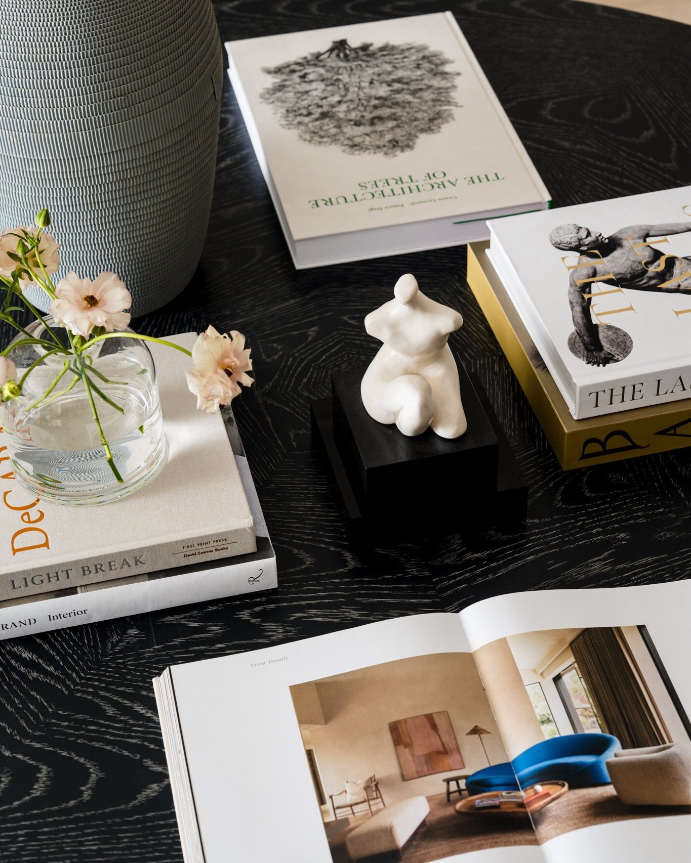 Swipe right to see how we buried the lede.

The sculptural tabletop details caught my eye first, but the full space deserves its moment too. Warm wood, original artwork, soft curves, and layers of texture inside this luxury Dallas condo tower designe