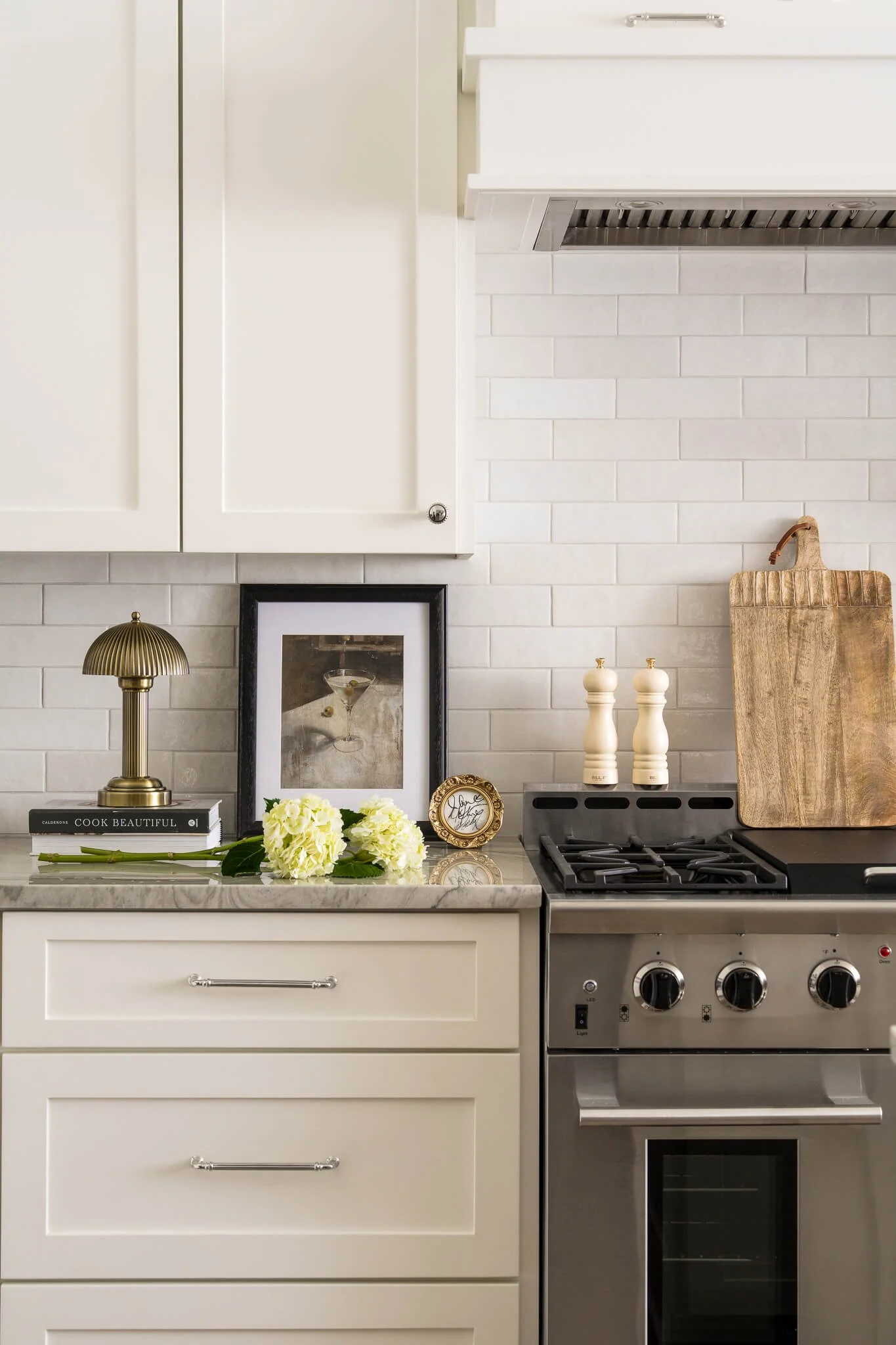 Cozy modern cottage kitchen vignette featuring greek isles paint, polished chrome hardware, Austin Interior Design Photography