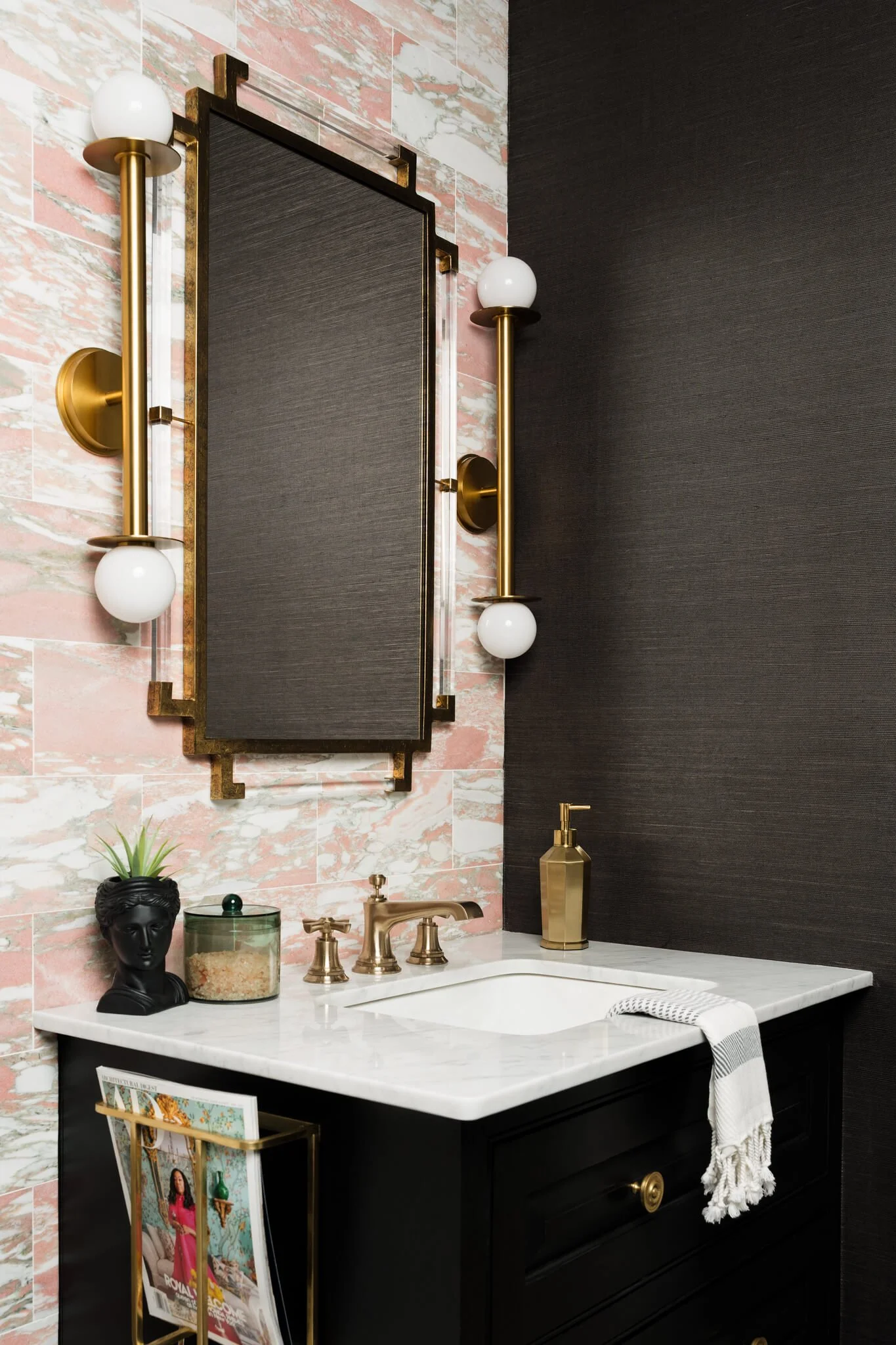 Moody powder bathroom with black textured walls, brass sconces, and marble vanity photographed by Dallas interior photographer Stacy Markow.