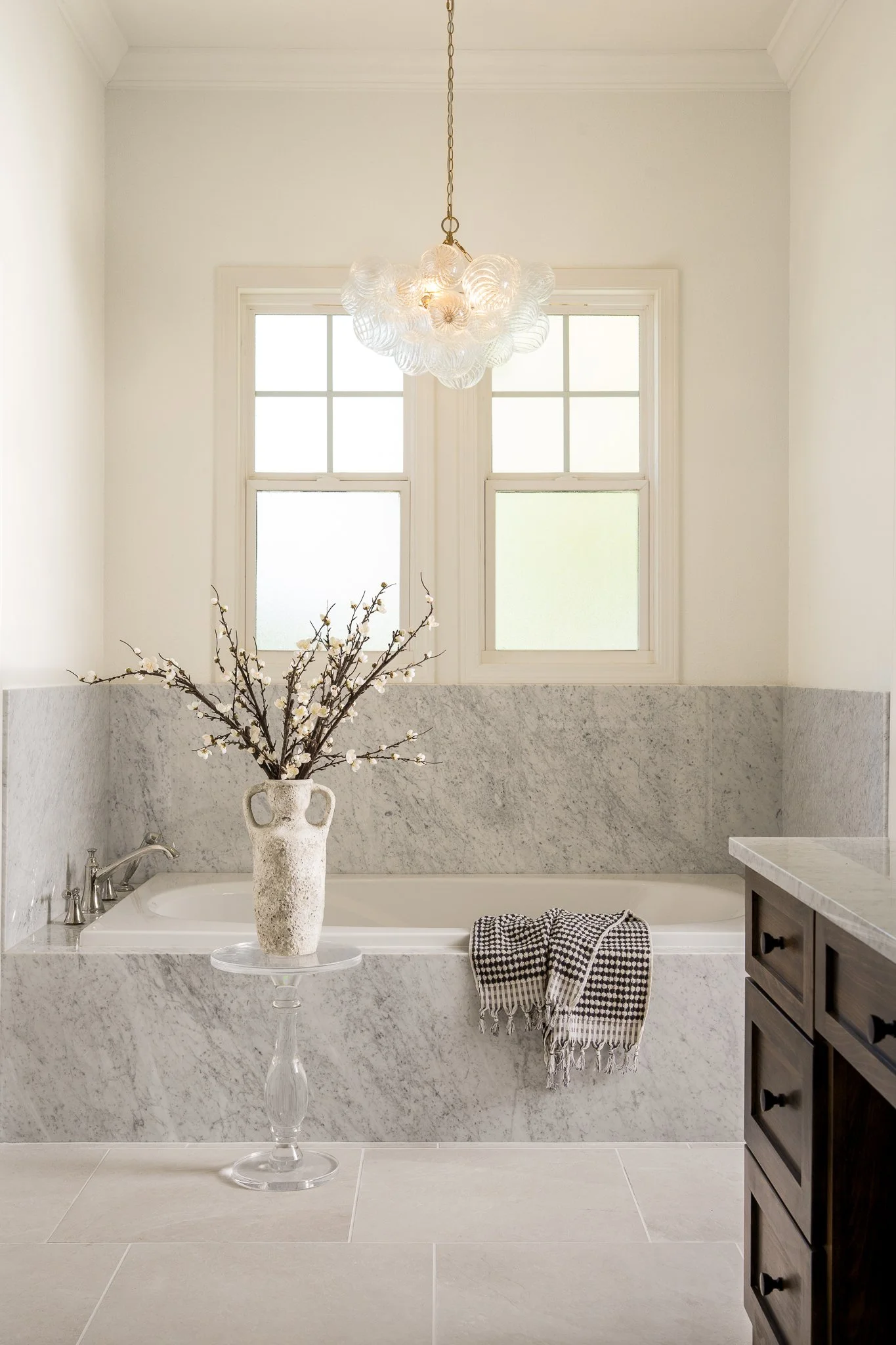 Bright cottage bathroom with traditional vanity and rustic details in Austin home.