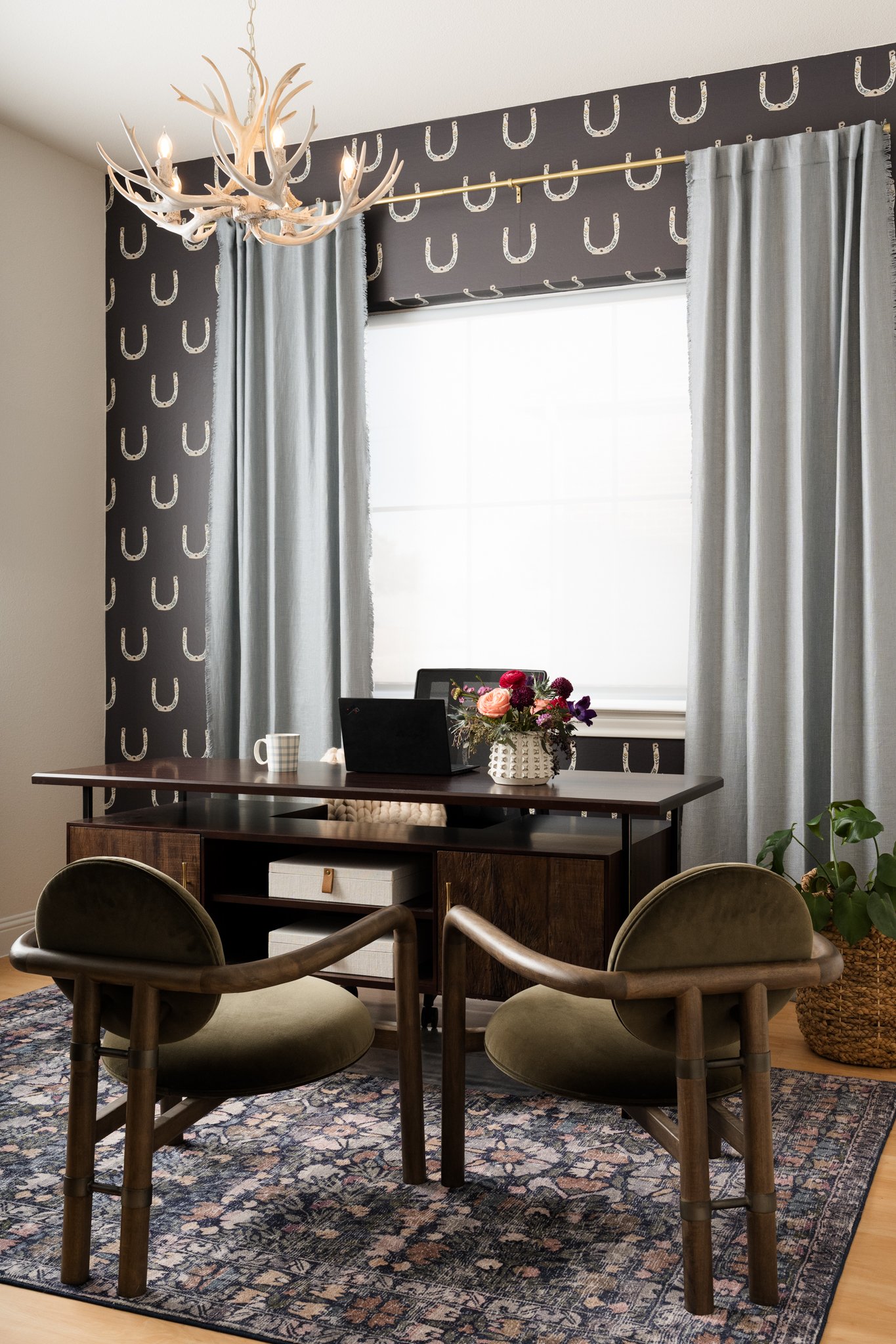 Modern western texas office with horseshoe charcoal gray wallpaper, green velvet chairs, and dusty blue curtains. Stacy Markow Dallas Commercial Architecture Photographer
