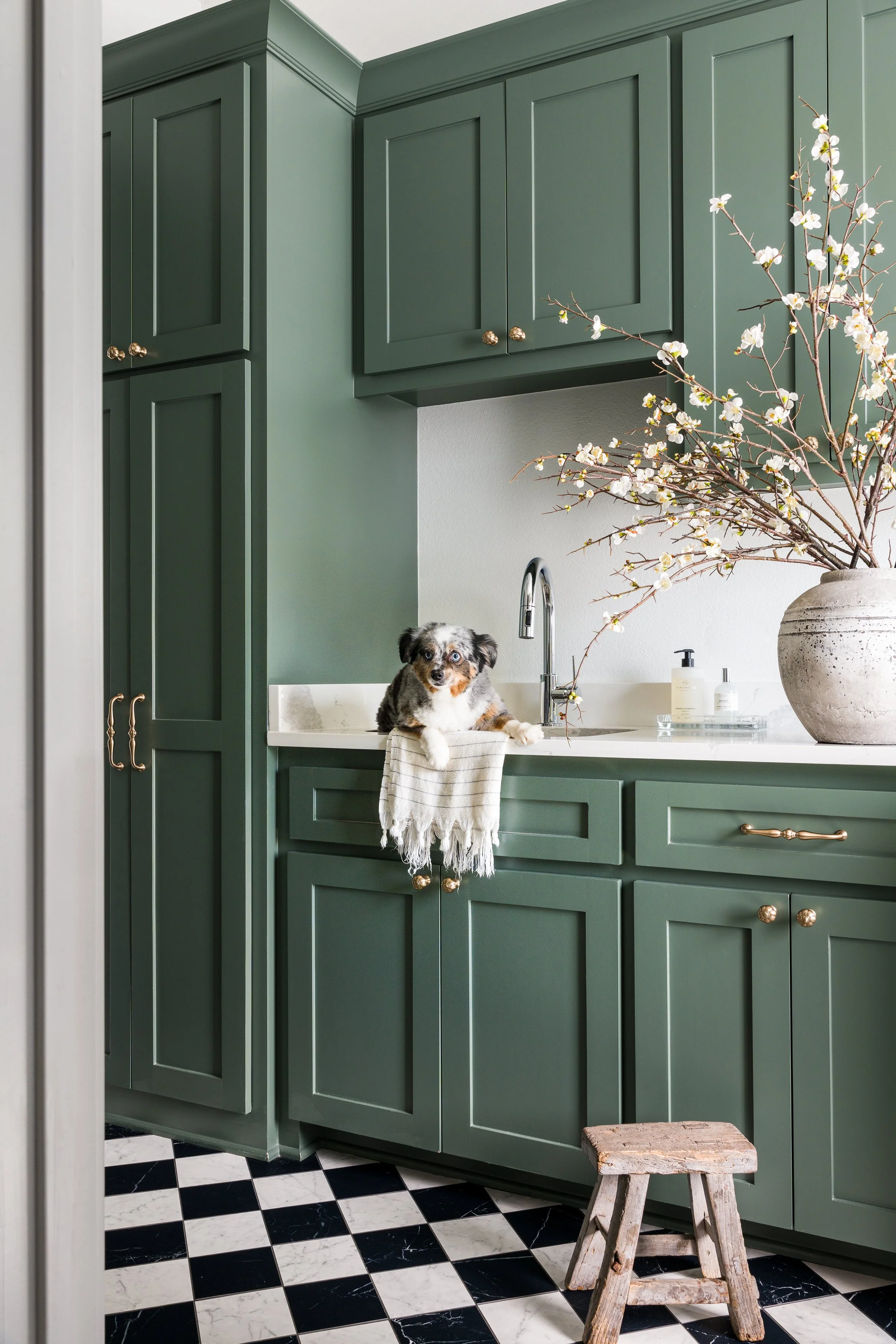 Modern Laundry room featuring green cabinetry and marble flooring. Design by Brittney Lane Interiors. Stacy Markow Dallas Fort Worth Interior Design Photographer