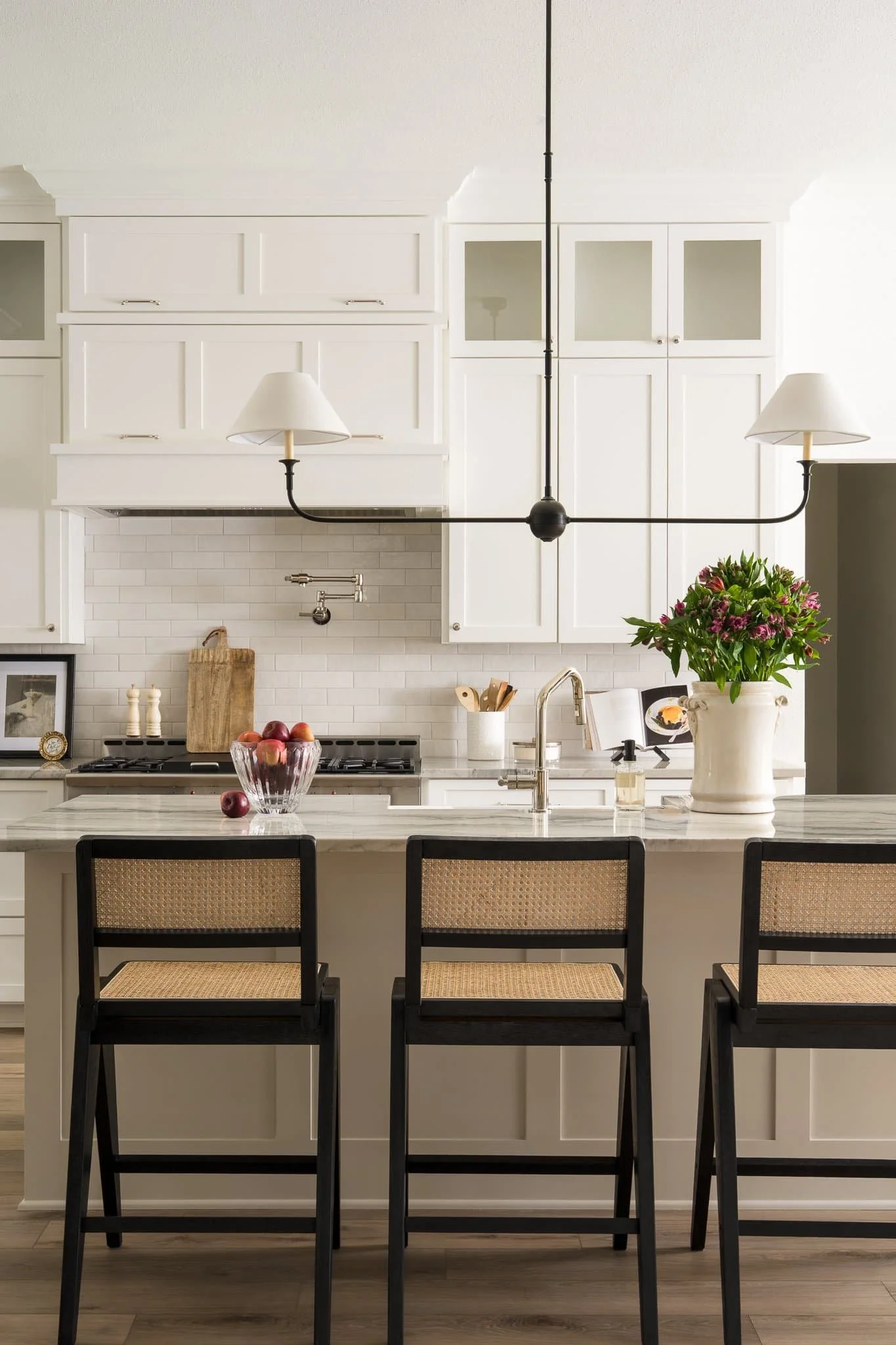 Traditional Modern Kitchen with white cabinets and black cane barstools Texas Interior Design Photographer