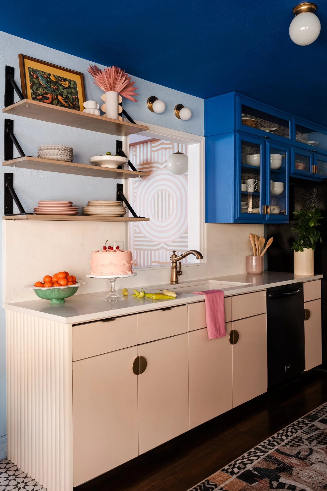 Blue and peach kitchen with open shelving and colorful styling, interior design photography Dallas. Design by A Bold New Hue. 