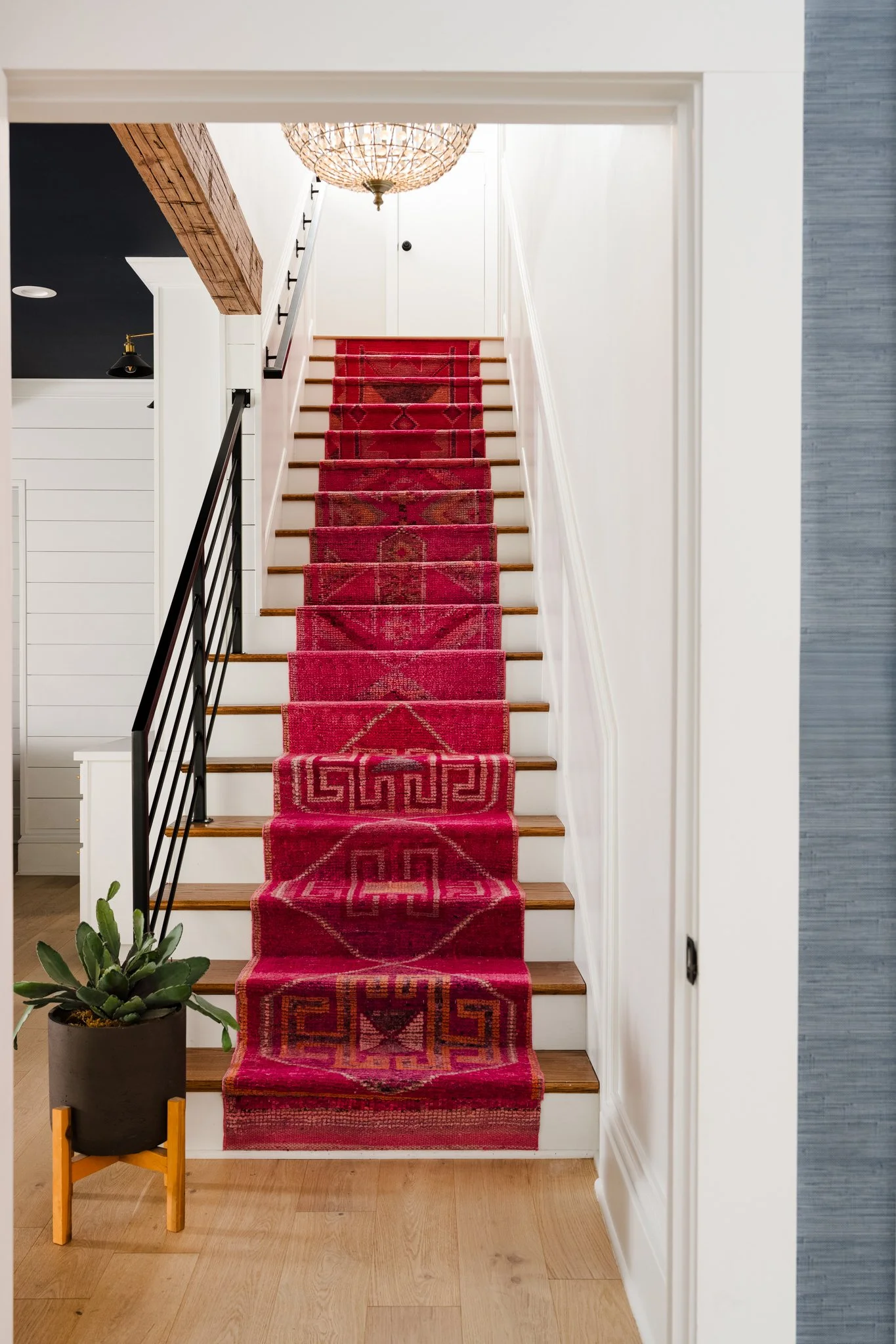 Staircase with red runner and graphic pattern
