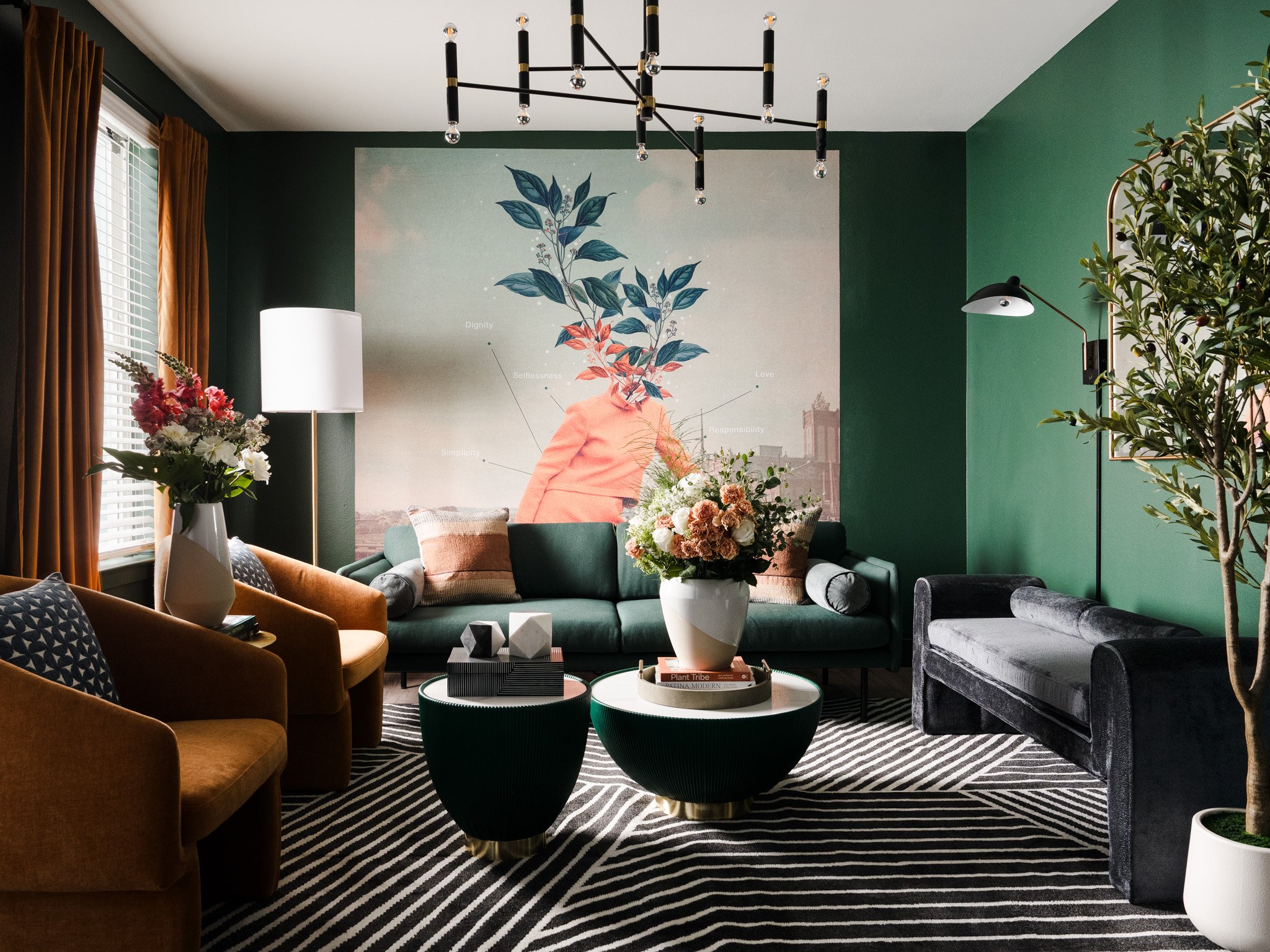 Green living room with mural art, sculptural furniture, and layered textures. Design by Artbuckle & Co. 
