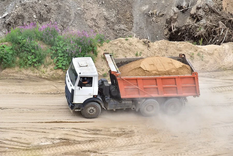 Professional dump truck hauling services for sand, gravel, and construction materials delivered safely and efficiently.