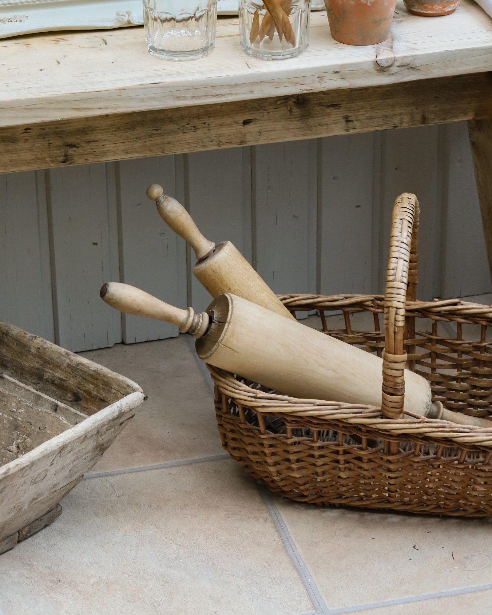 French basket with vintage rolling pins inside