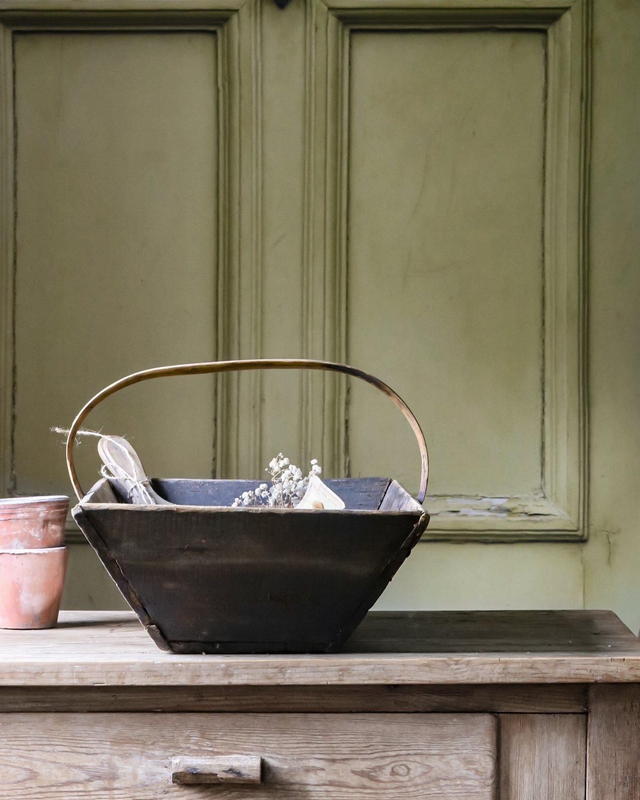 Antique French farmhouse trug on a rustic table