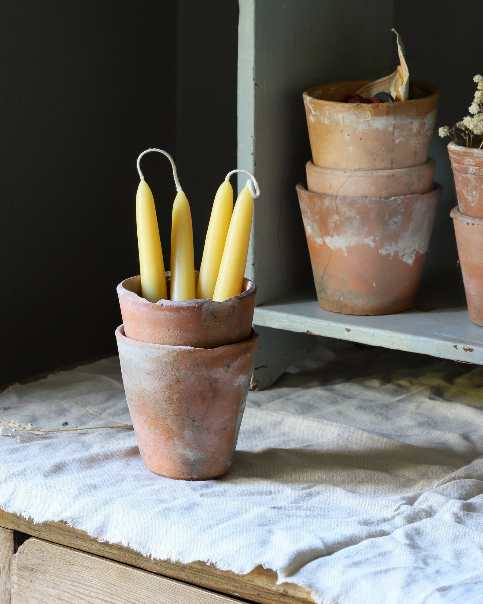 Beeswax taper candle pair in a rustic terracotta pot