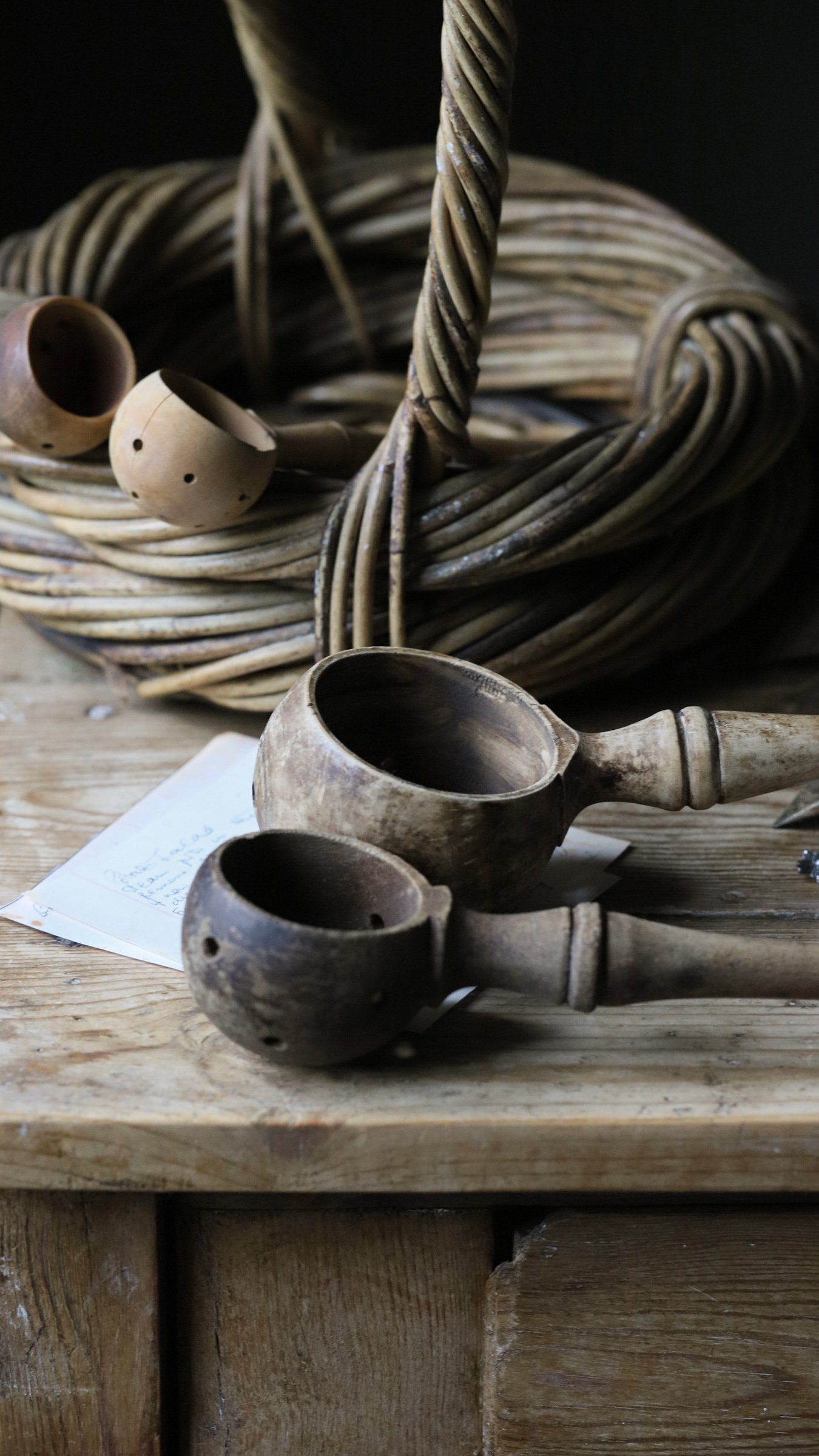 French olive scoops laid on a rustic table